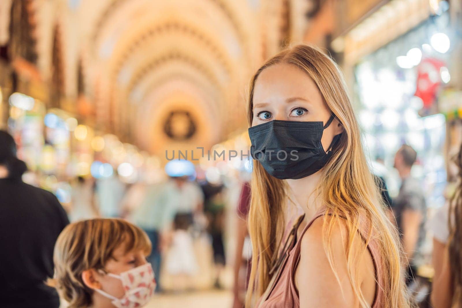 A tourist woman walks among the countless shops at the Grand Bazaar and Egyptian Bazaar in Istanbul. Shopping and travel in Turkey concept. Istanbul historical Egyptian Bazaar. Misir Carsisi, spice market. Turkiye.