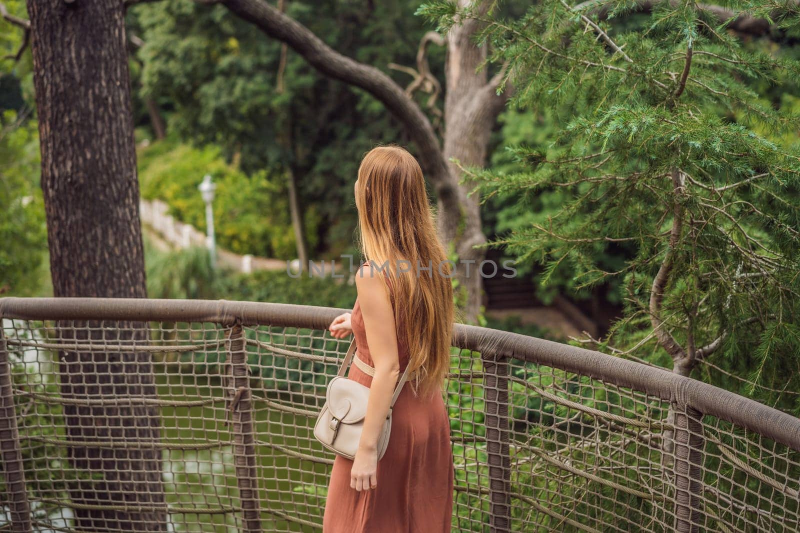Woman tourist in Rope bridge in Yildiz Park. Besiktas, Istanbul, Turkey. Turkiye.