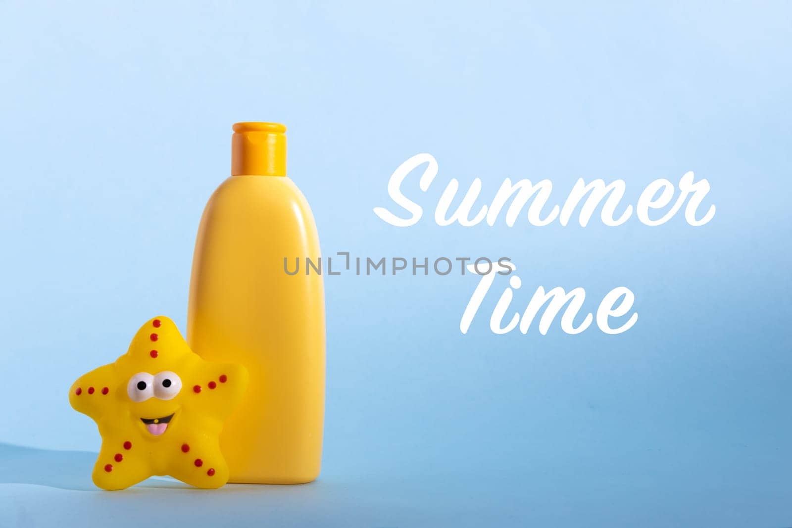 Yellow plastic bottle with baby cosmetic and funny toy. Sunscreen lotion. The concept of children's sun protection. Text Summer time. by Ri6ka