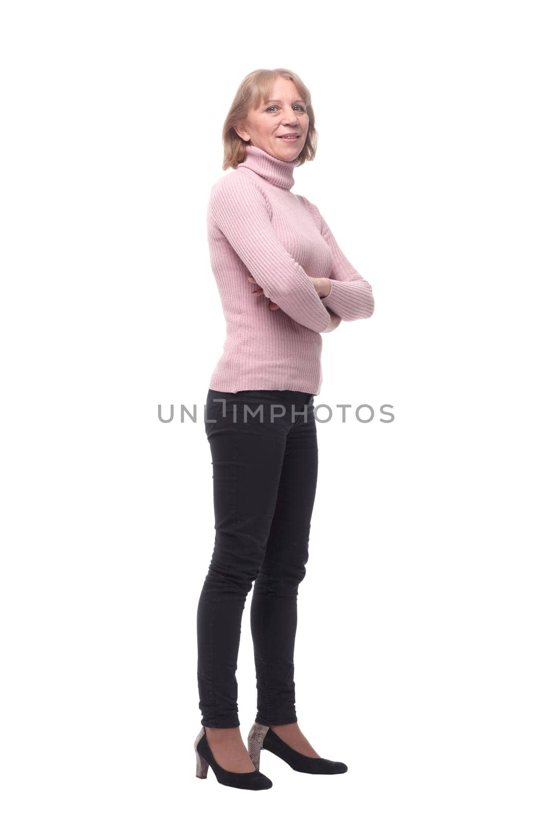 Full length, side view of a confident business woman standing with folded hands isolated over white background