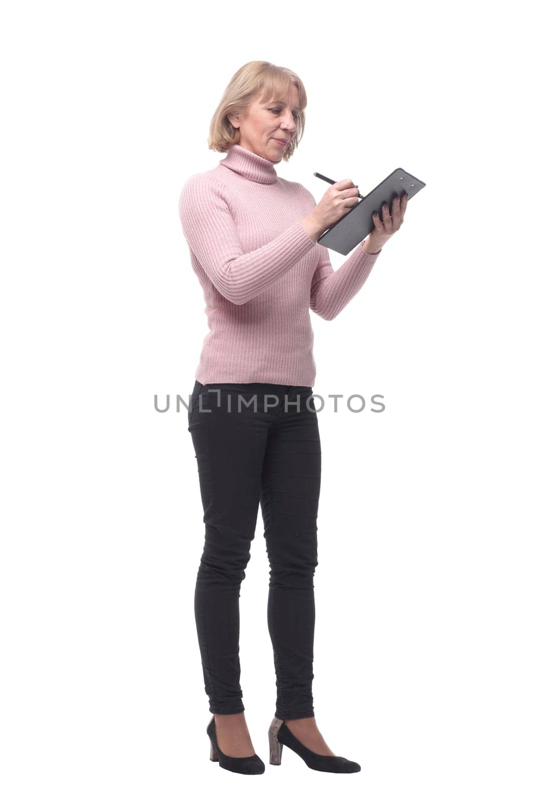 Full length portrait of smiling business woman pointing on blank clipboard isolated over white background