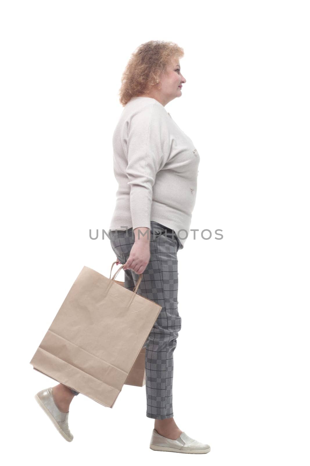 full-length. casual adult woman with shopping bags. isolated on a white background.