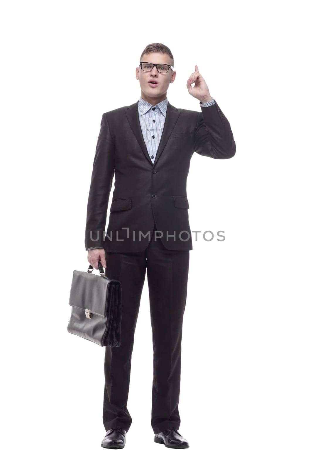in full growth. smiling young businessman with a leather briefcase. isolated on a white background.