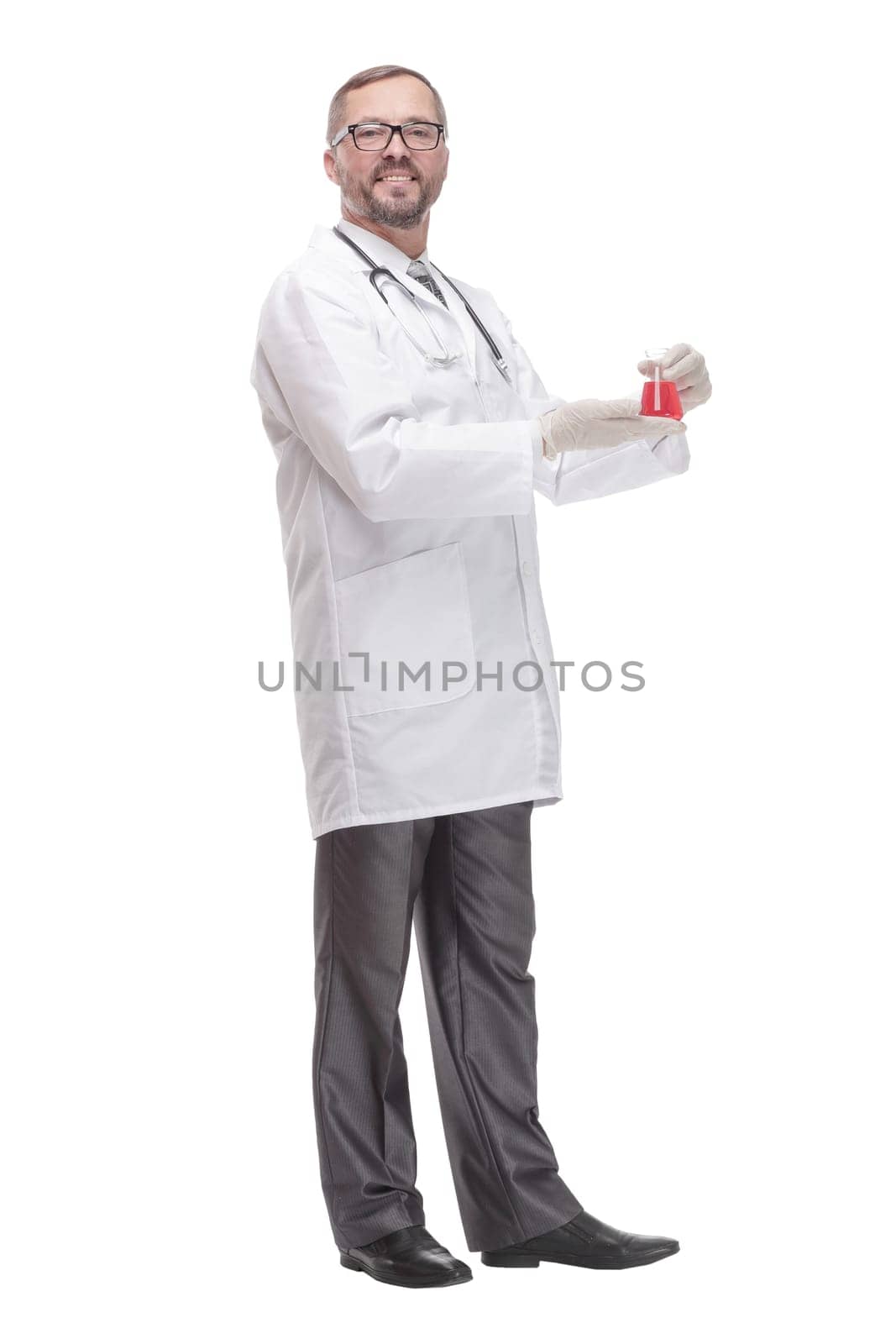 smiling doctor with a laboratory flask in his hands . isolated on a white background.