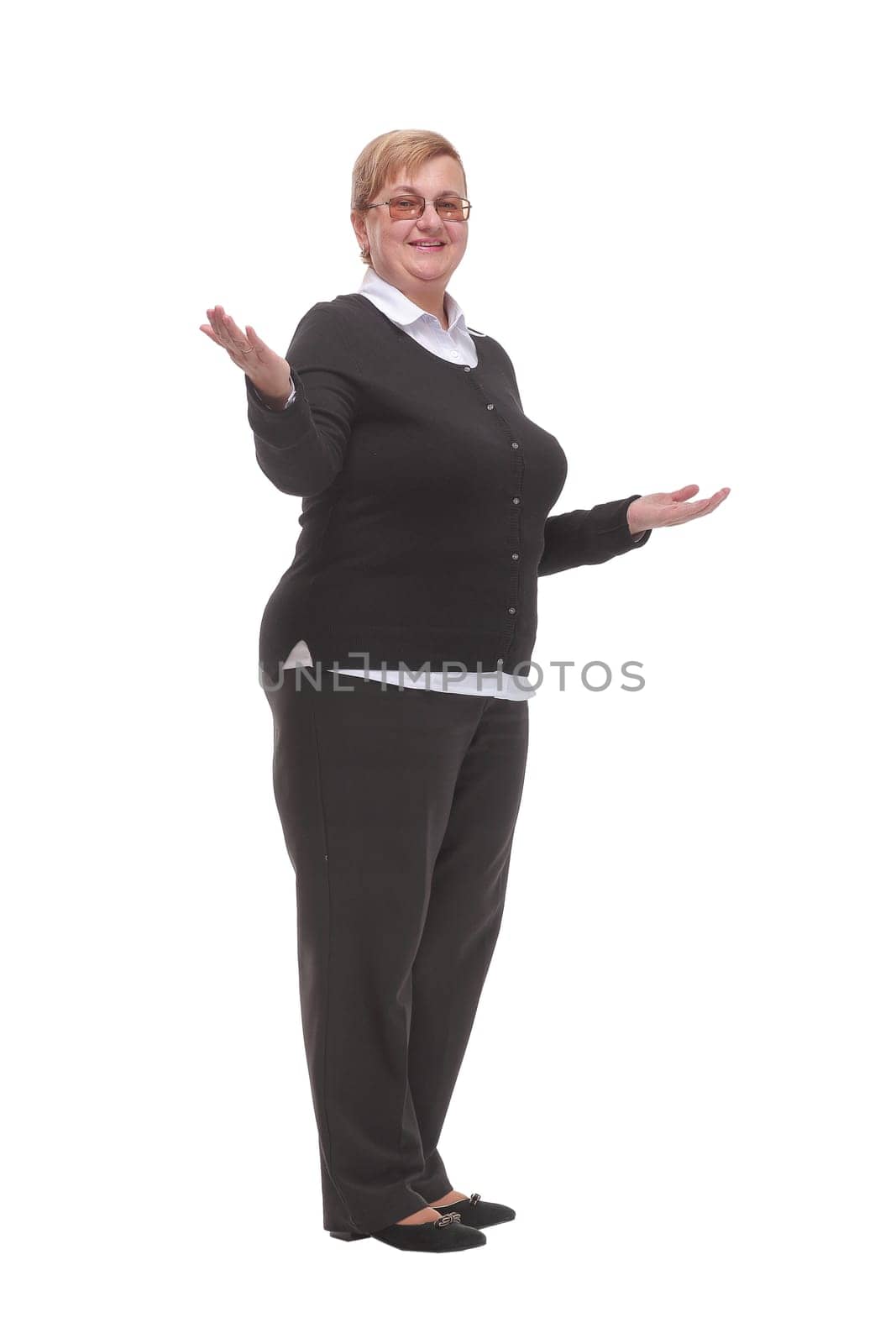 Mature woman shows her hands in different directions, standing on a white background. Successful senior woman. Teacher.