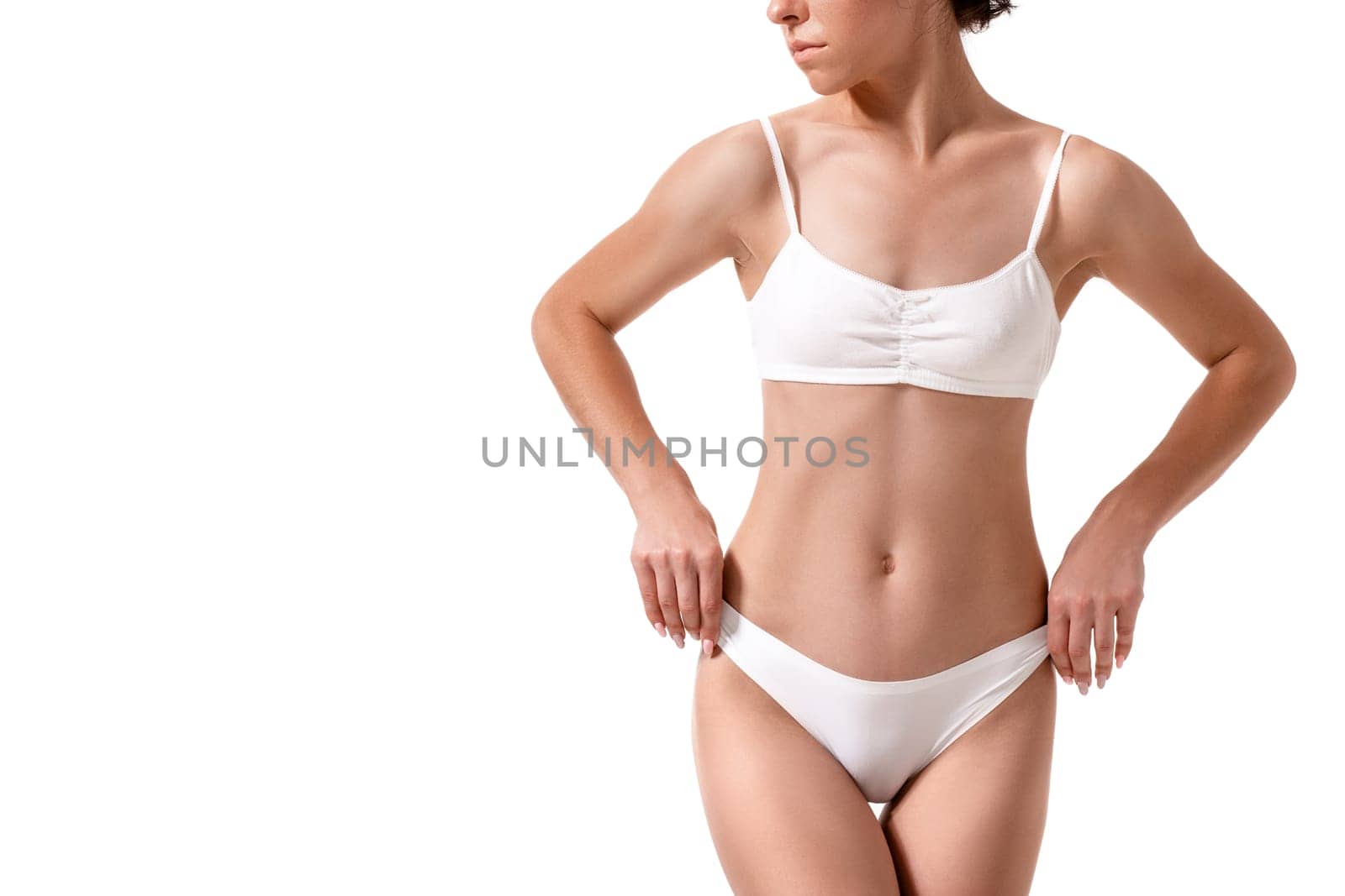 Slim tanned woman's body. Isolated over white background. Diet. Sport. Health plastic surgery