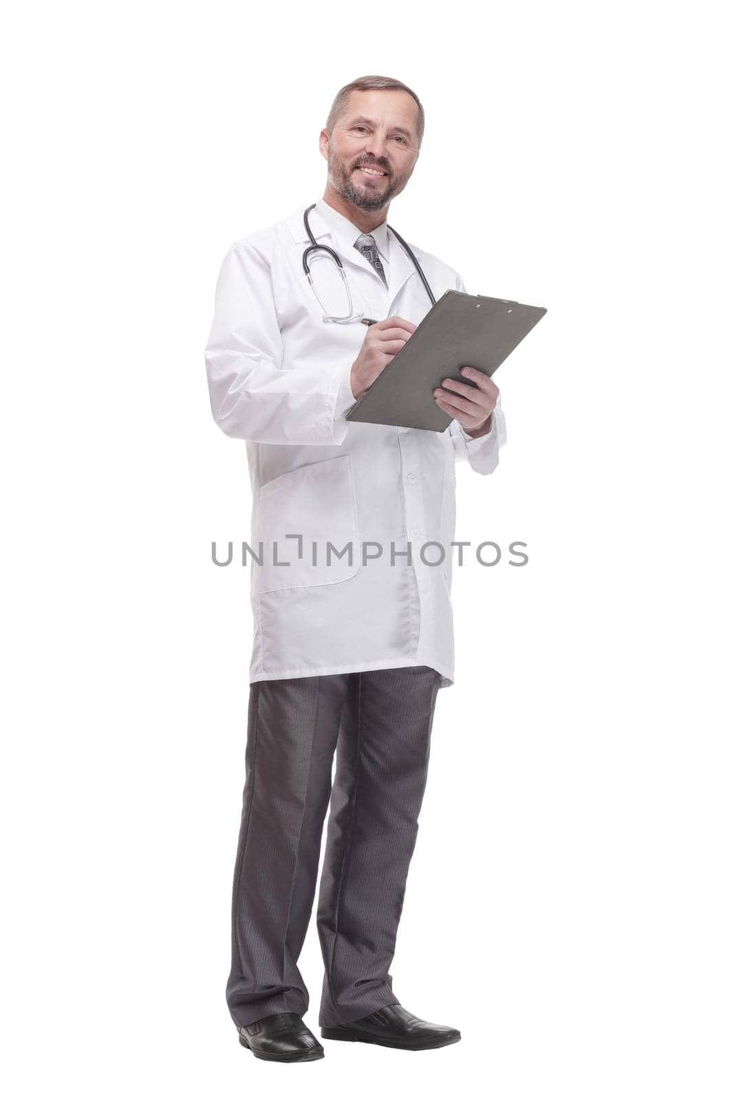 in full growth. smiling doctor with clipboard . isolated on a white background.