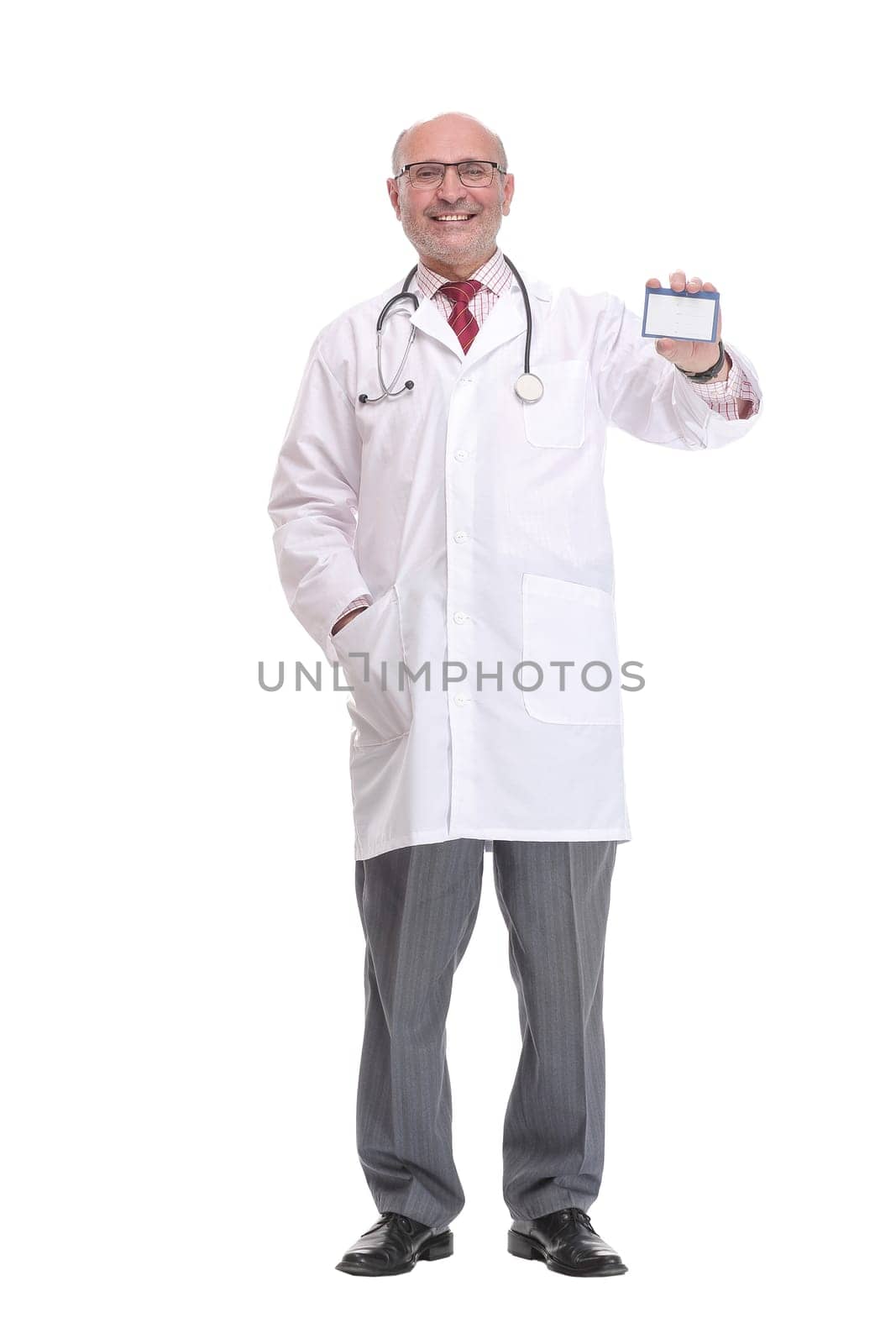 Portrait of confident mature doctor showing his business card and smiling while standing against white background