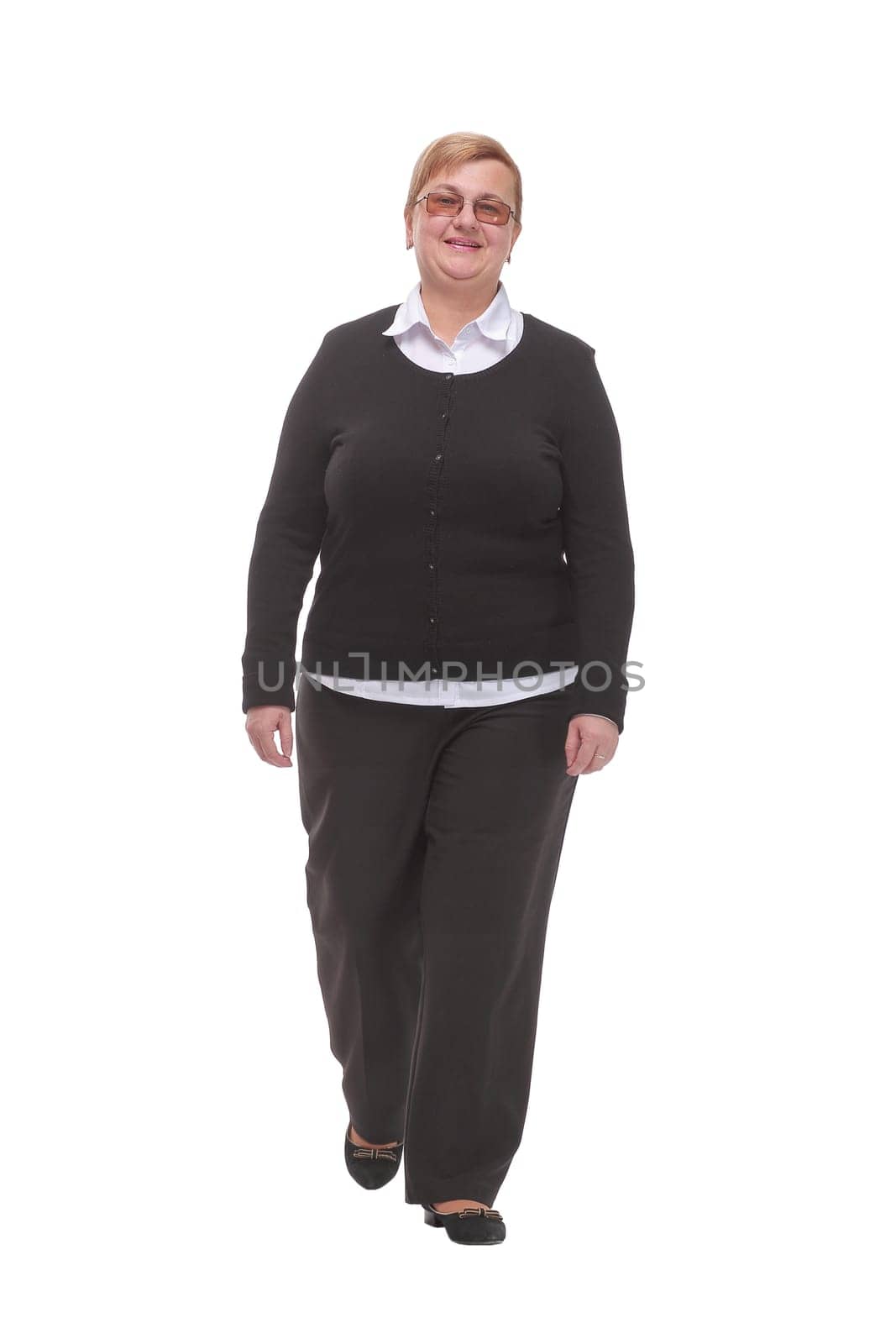 Full length profile shot of an elderly woman walking isolated on white background