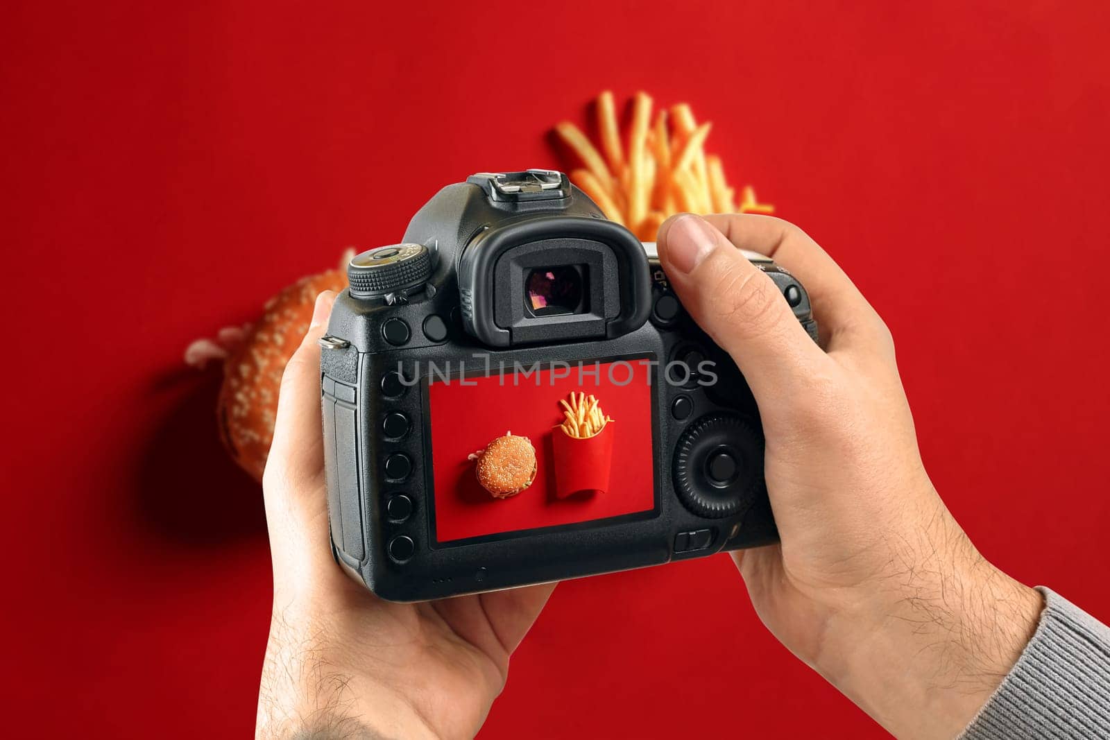 Digital single-lens reflex camera in hands. Man photographer makes photos. Male hands hold the camera close-up by nazarovsergey