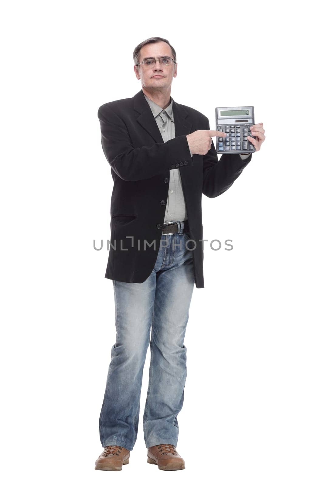 in full growth. serious business man with a calculator. isolated on a white background.