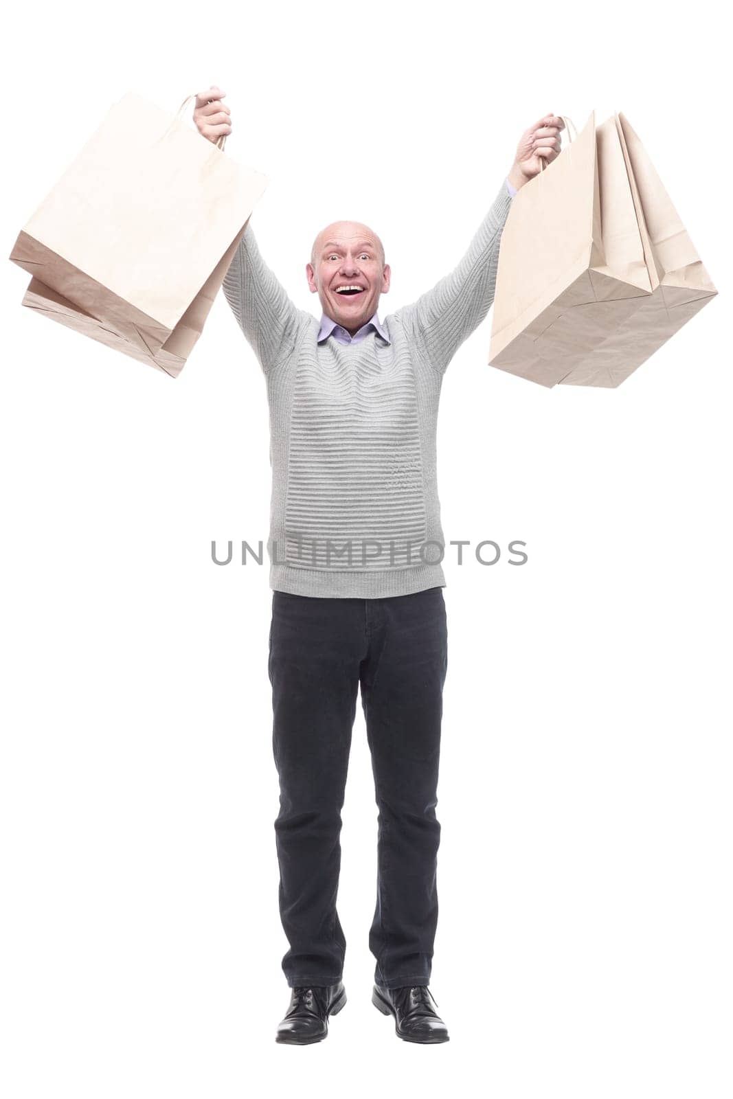 in full growth. happy man with shopping bags. isolated on a white background.
