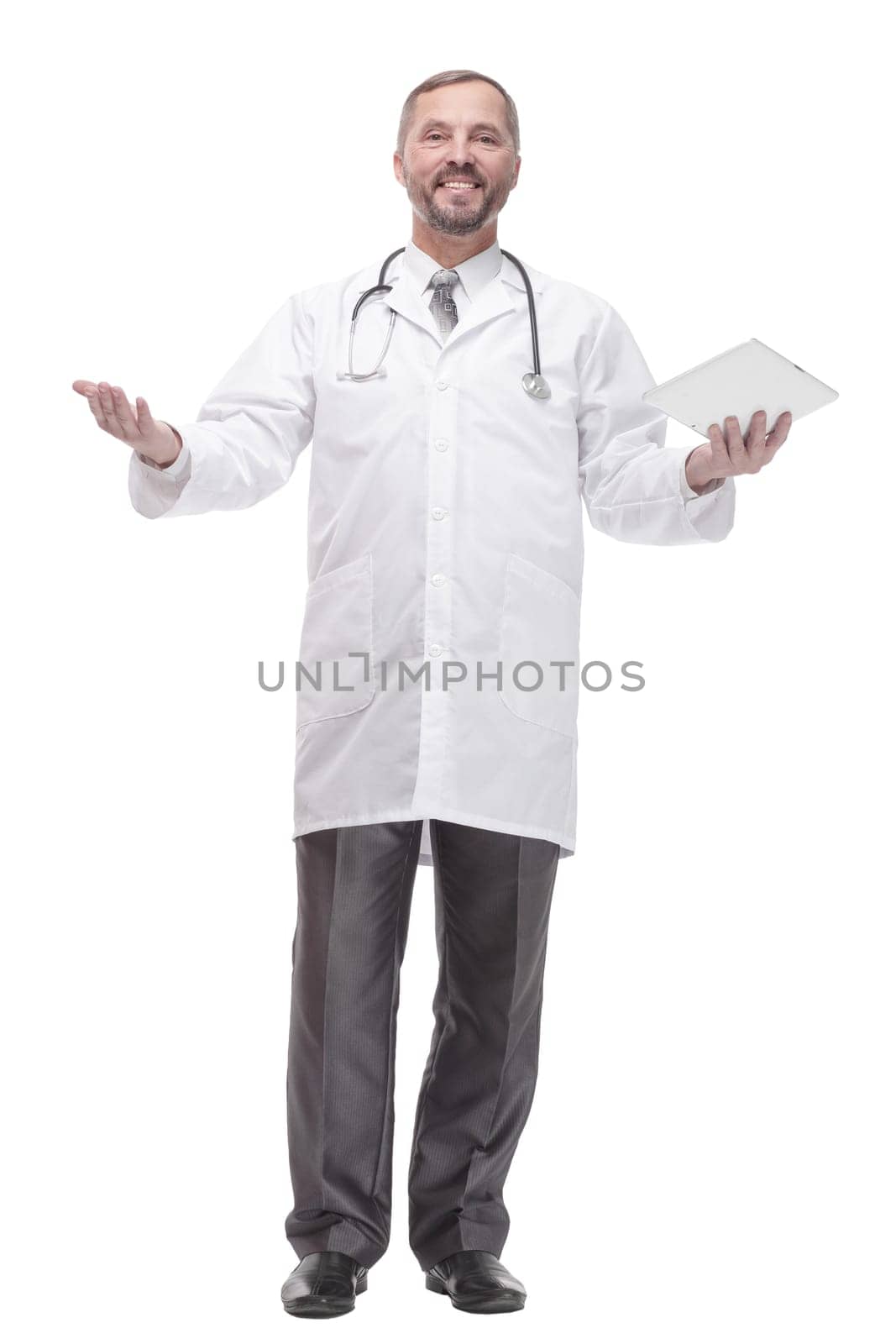 in full growth. smiling doctor with a digital tablet . isolated on a white background.