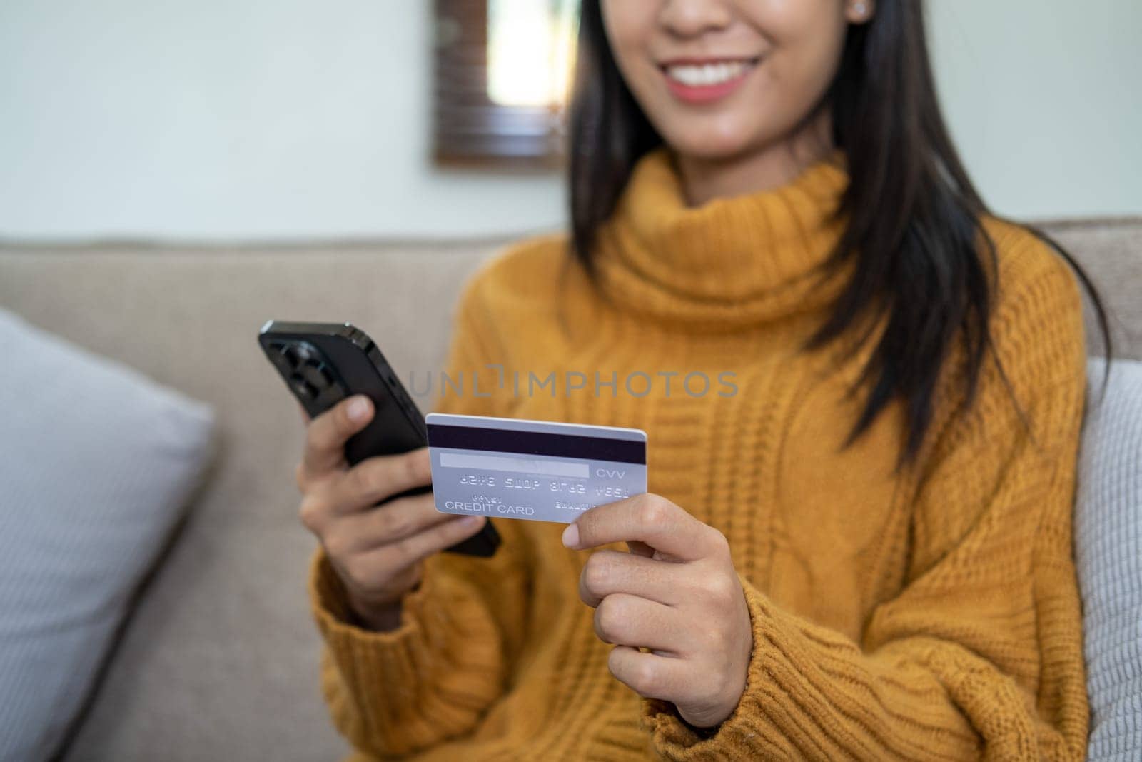 Happy smart young woman Asian using smartphone for shopping, mobile shopping, beautiful woman doing online purchases, shopping online. High quality photo