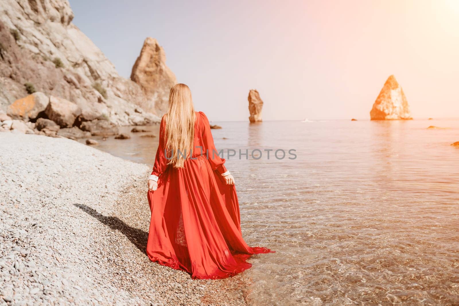 Woman travel sea. Happy tourist taking picture outdoors for memories. Woman traveler looks at the edge of the cliff on the sea bay of mountains, sharing travel adventure journey.