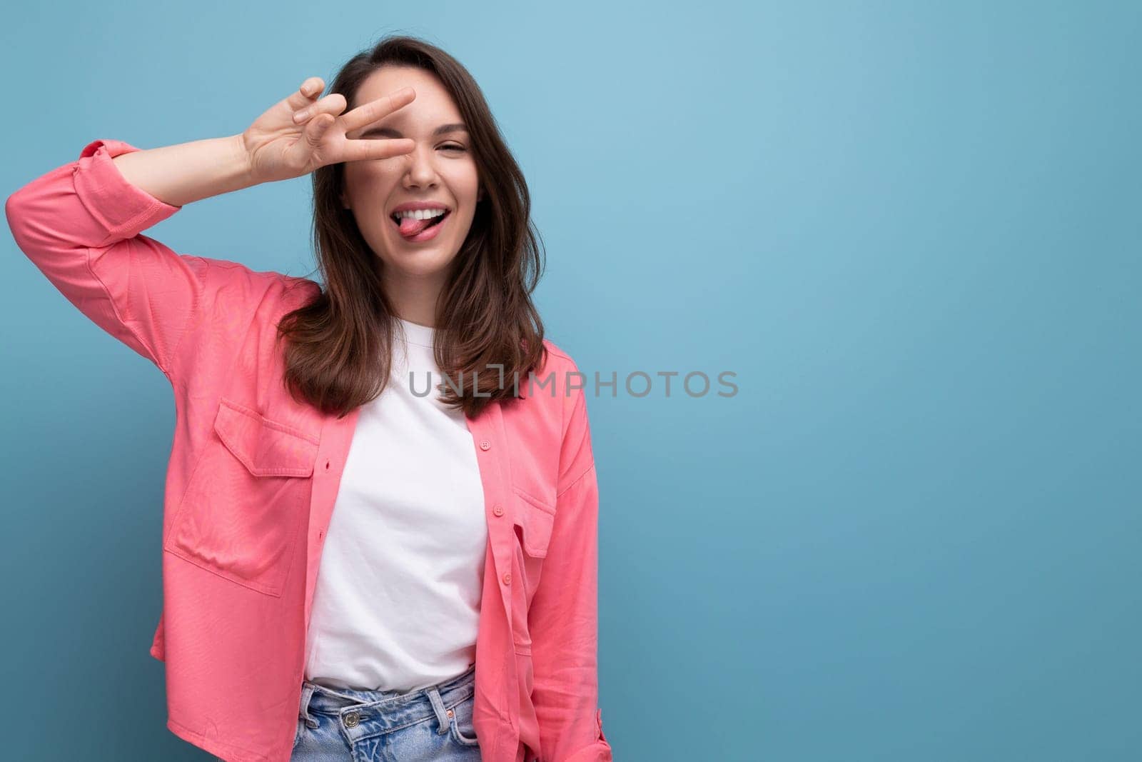 optimist young lady in shirt and jeans on studio isolated background.