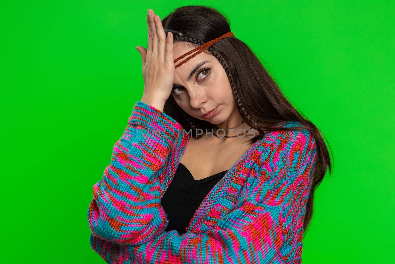 Face palm. Shame on you. Upset disappointed young woman making face palm gesture, feeling bored, disappointed in result, bad news. Hippie girl isolated on chroma key background, green screen, indoors