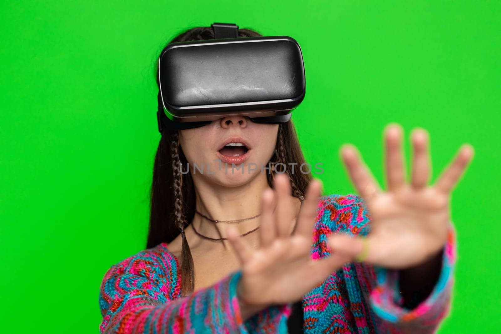 Woman using virtual reality futuristic technology VR app headset helmet to play simulation 3D 360 video game, watching film movie. Excited hippie girl isolated on chroma key background, green screen