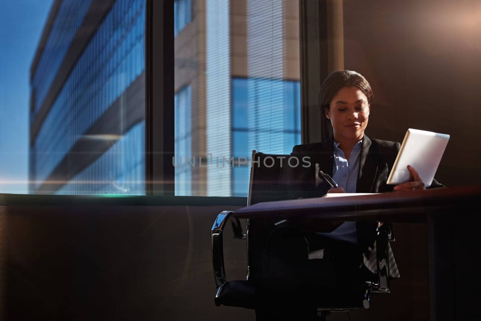 Nothing can take the place of persistence. a young woman using her digital tablet at her desk