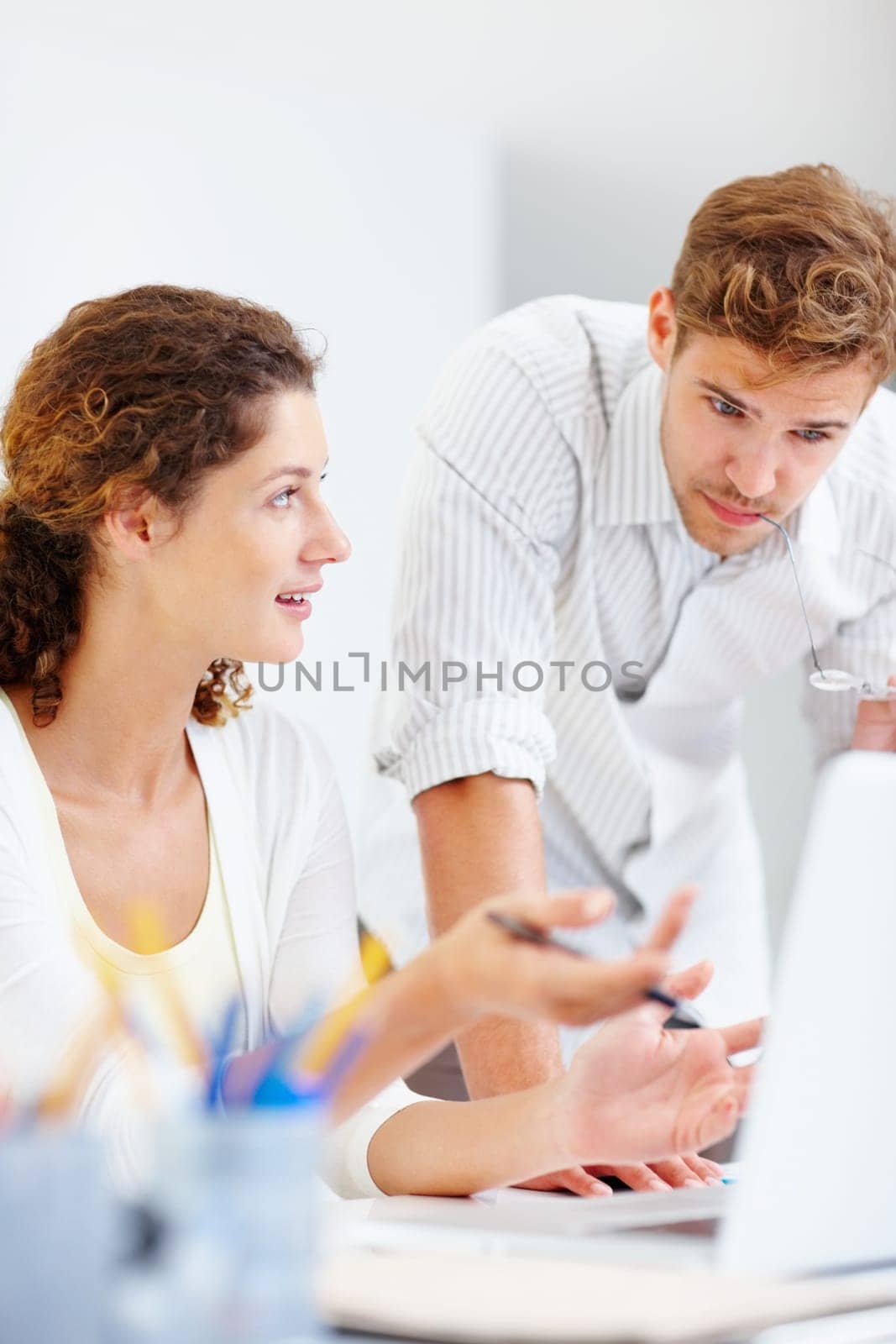 Business people using laptop. Two business people working on laptop and discussing with each other