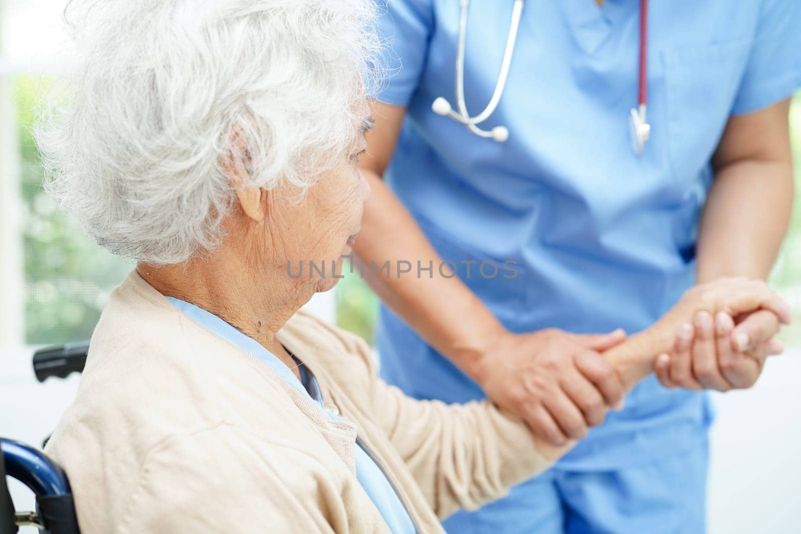 Doctor holding hands Asian elderly woman patient, help and care in hospital.