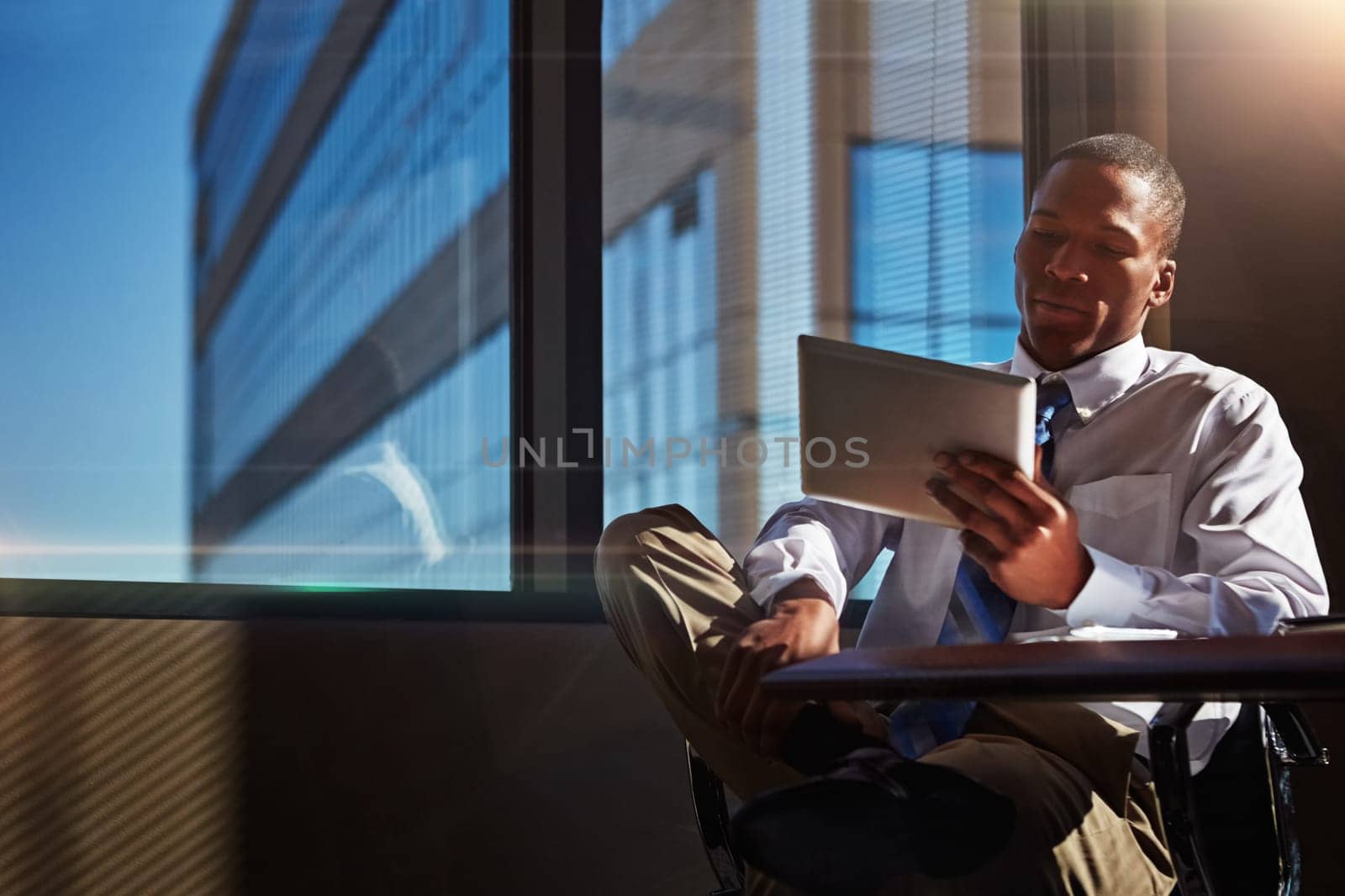 Use a tablet to serve the needs of your clients. a businessman using his digital tablet at his desk