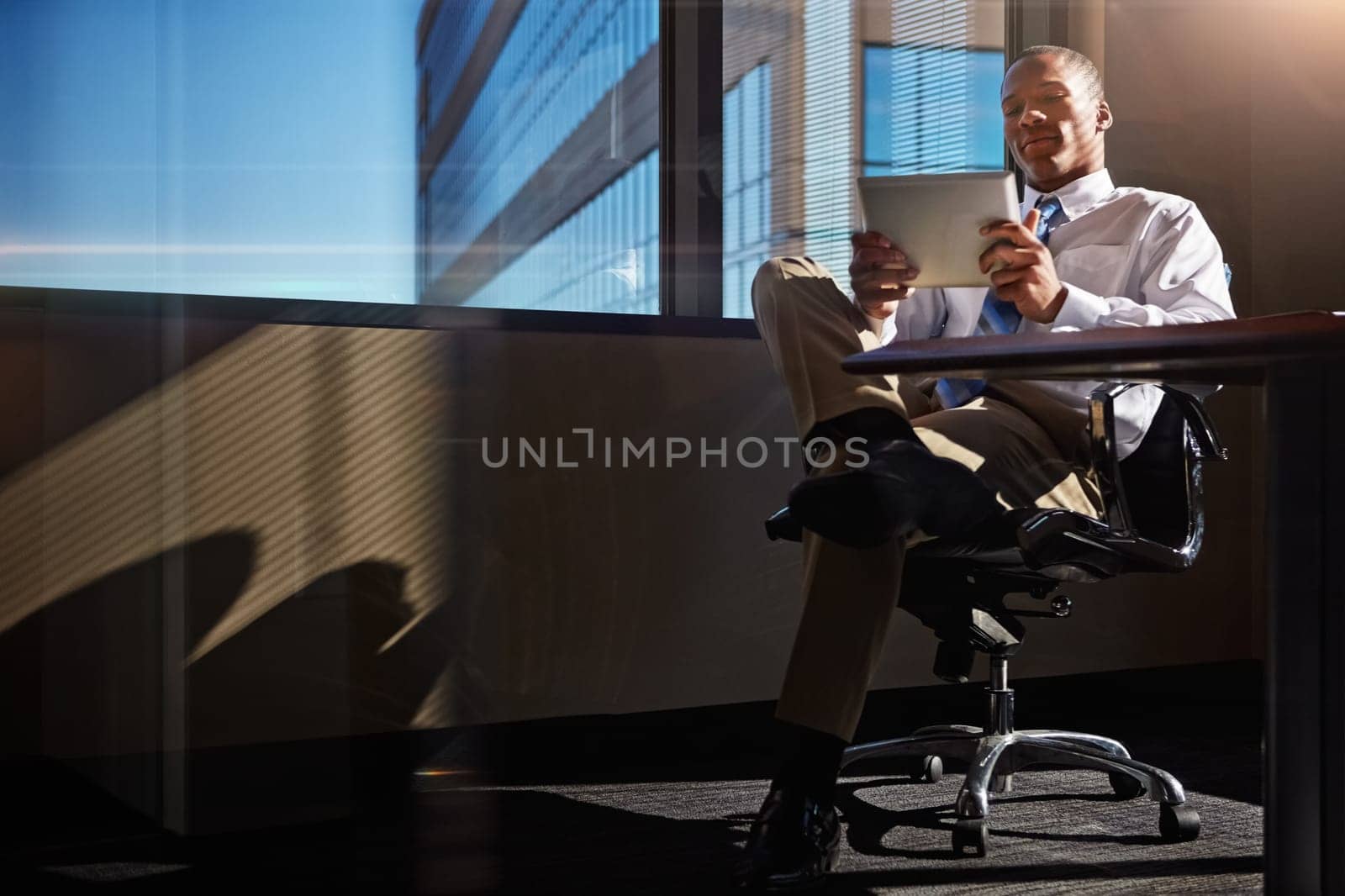 I found just the tool to solve my problems. a businessman using his digital tablet at his desk