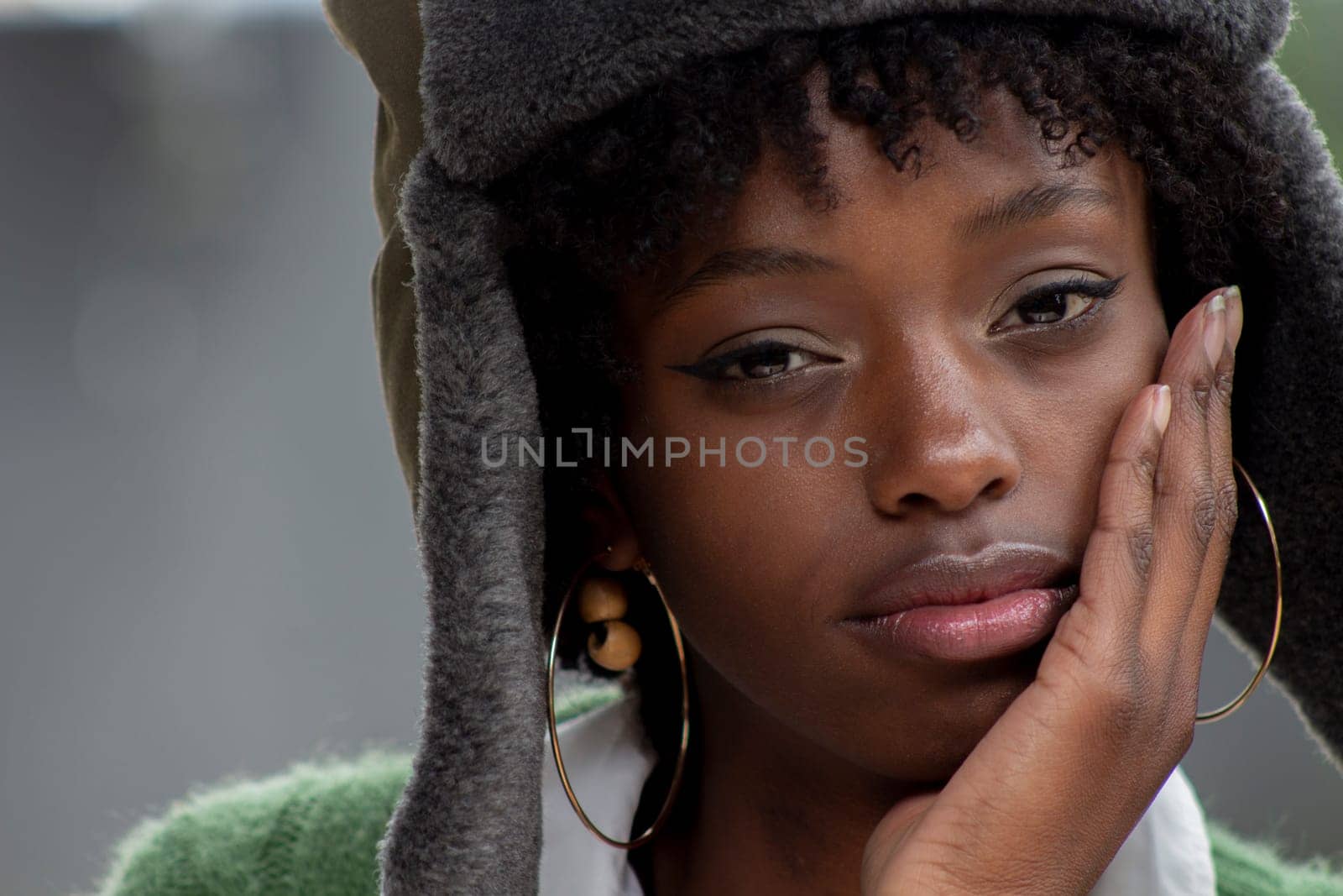 closeup of afro girl with military hat looking at camera