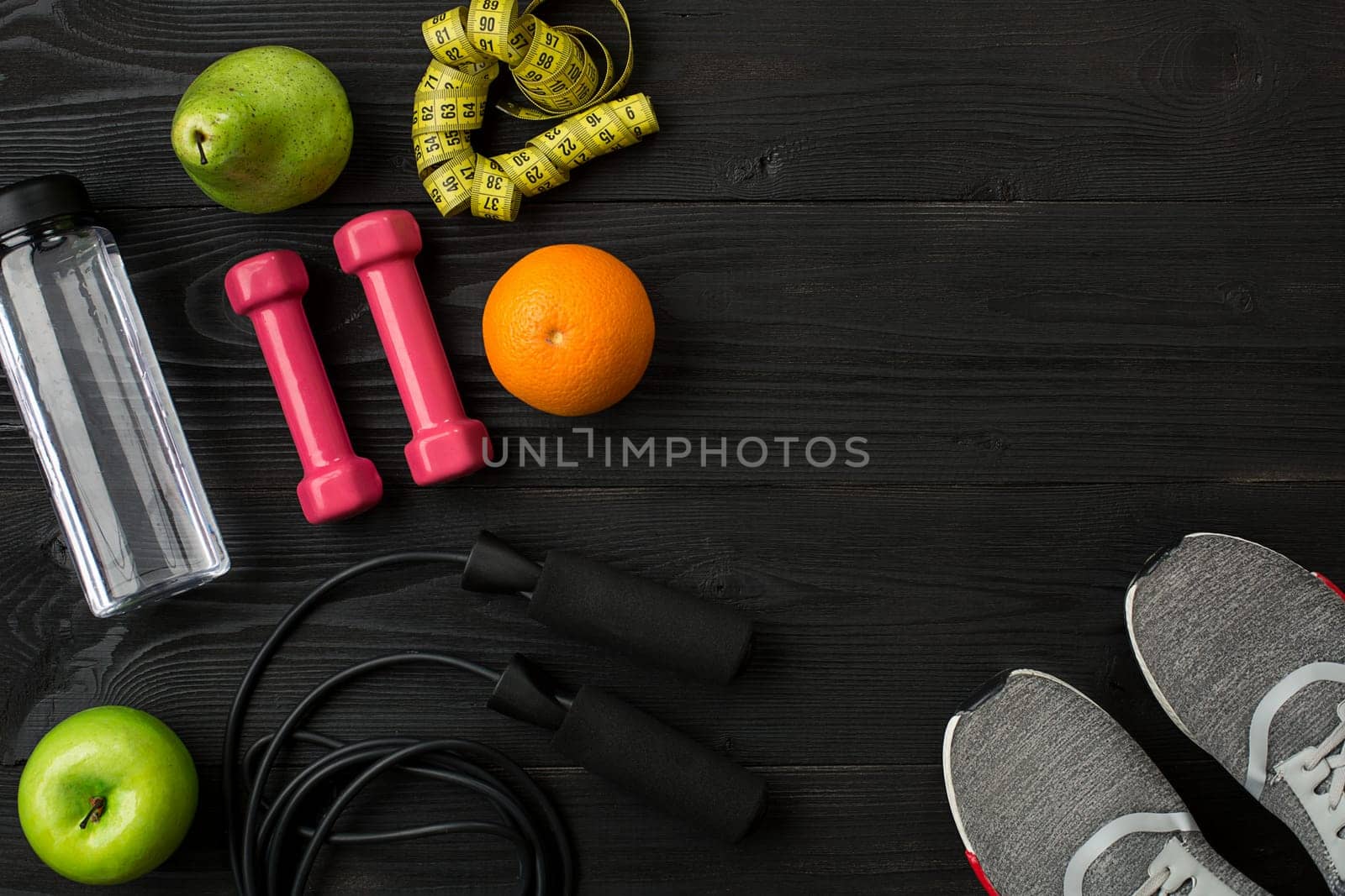 Sports equipment and wear on dark wooden background, top view. Copy space Still life. Ideal for blog.