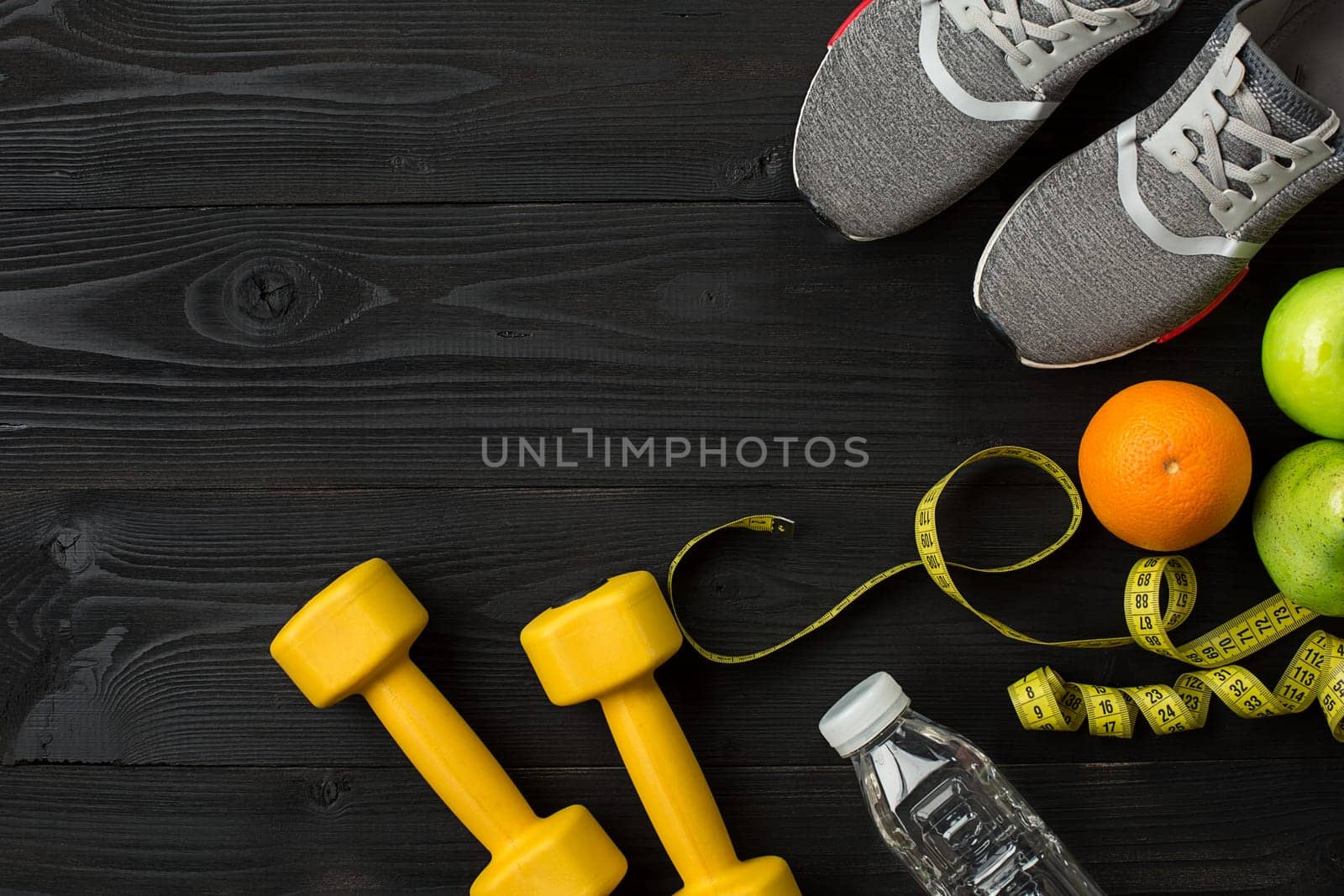 Sports equipment and wear on dark wooden background, top view. Copy space Still life. Ideal for blog.