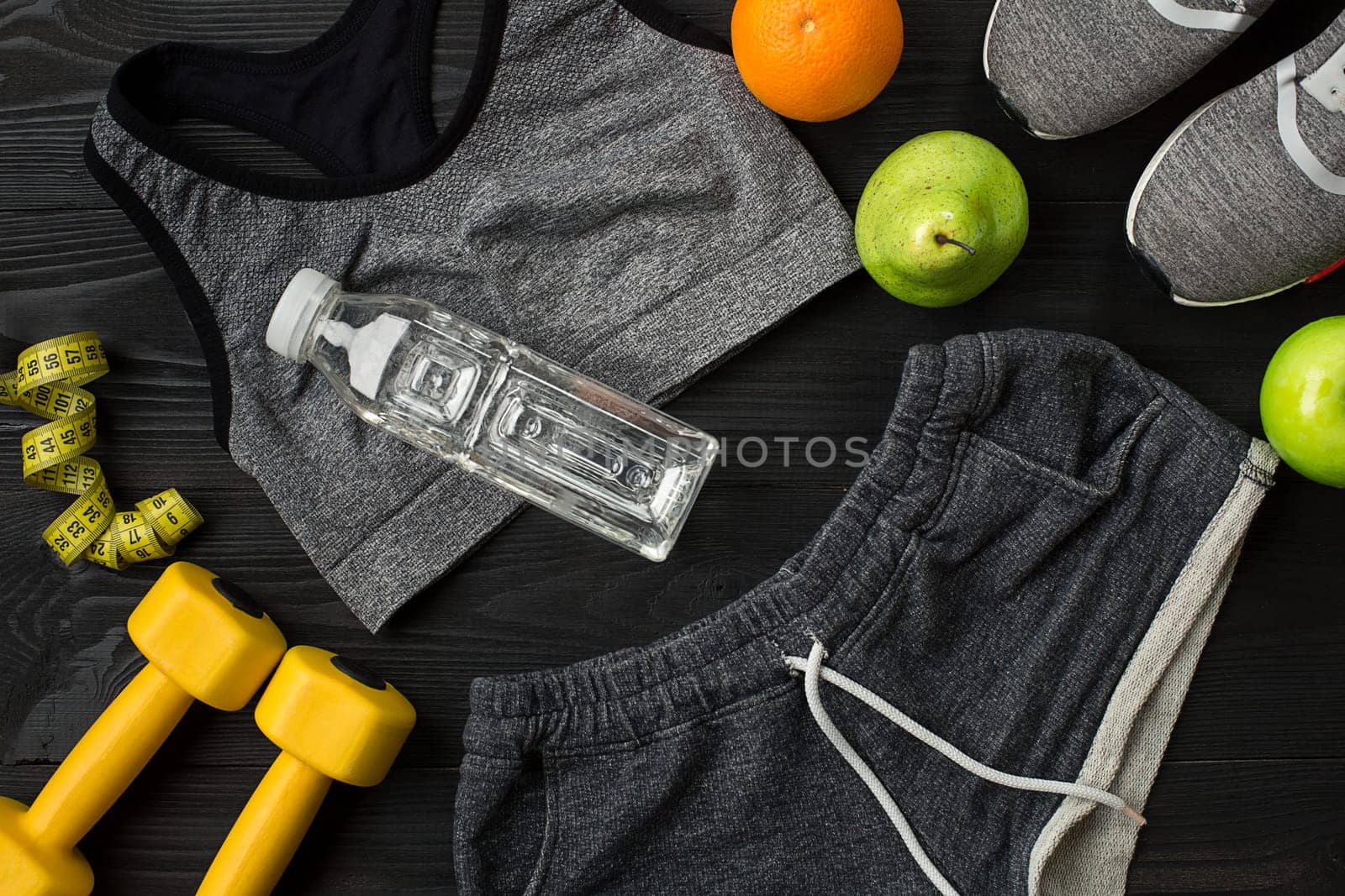 Sports equipment and wear on dark wooden background, top view. Copy space Still life. Ideal for blog.