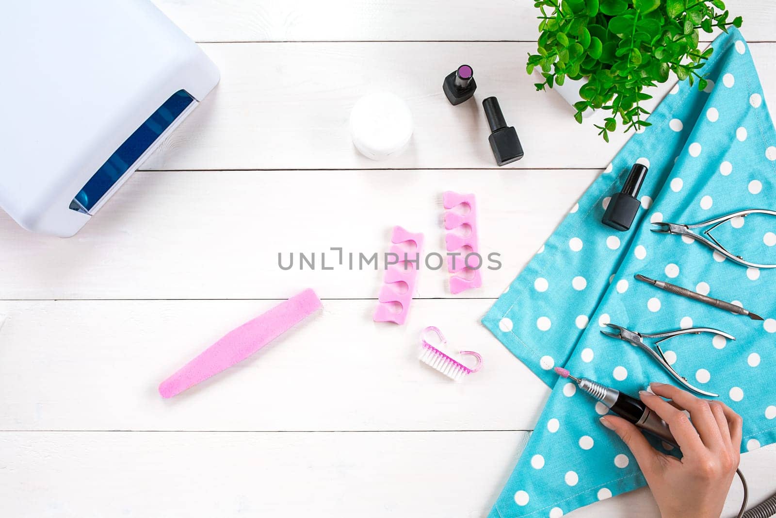 Manicure set and nail polish on wooden background. Top view. Copy space. Still life. Nail Care.