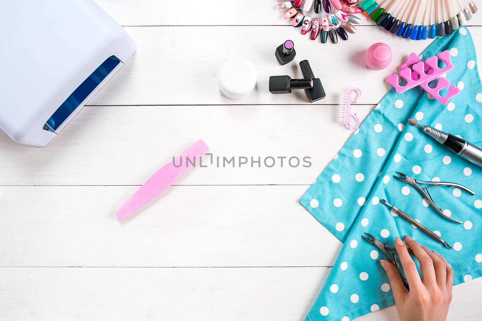 Manicure set and nail polish on wooden background. Top view. Copy space. Still life. Nail Care.