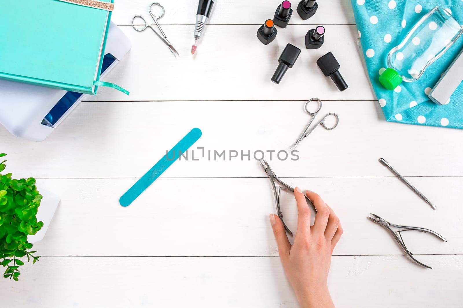 Manicure set and nail polish on wooden background. Top view. Copy space. Still life. Nail Care.