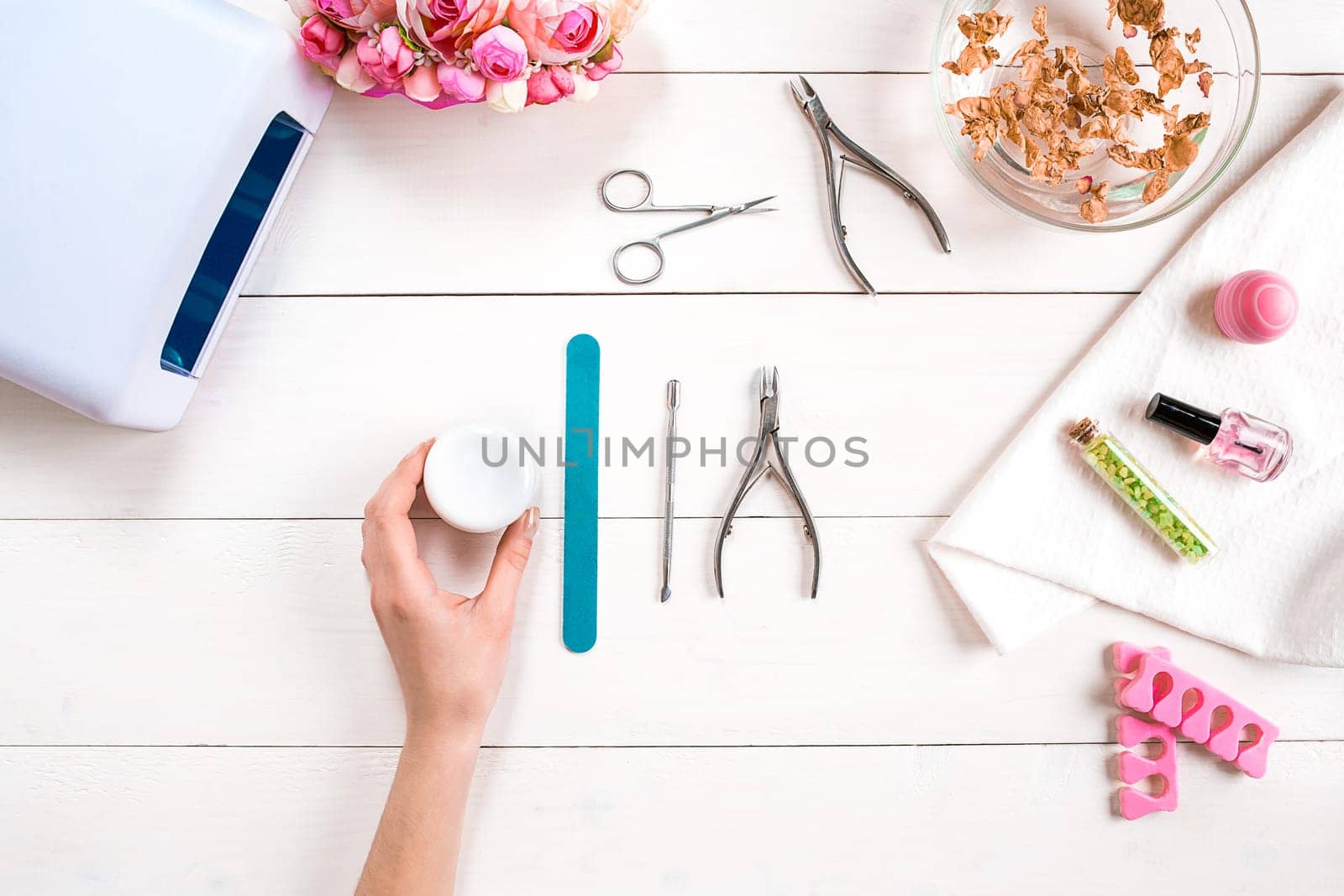 Manicure set and nail polish on wooden background. Top view. Copy space. Still life. Nail Care.