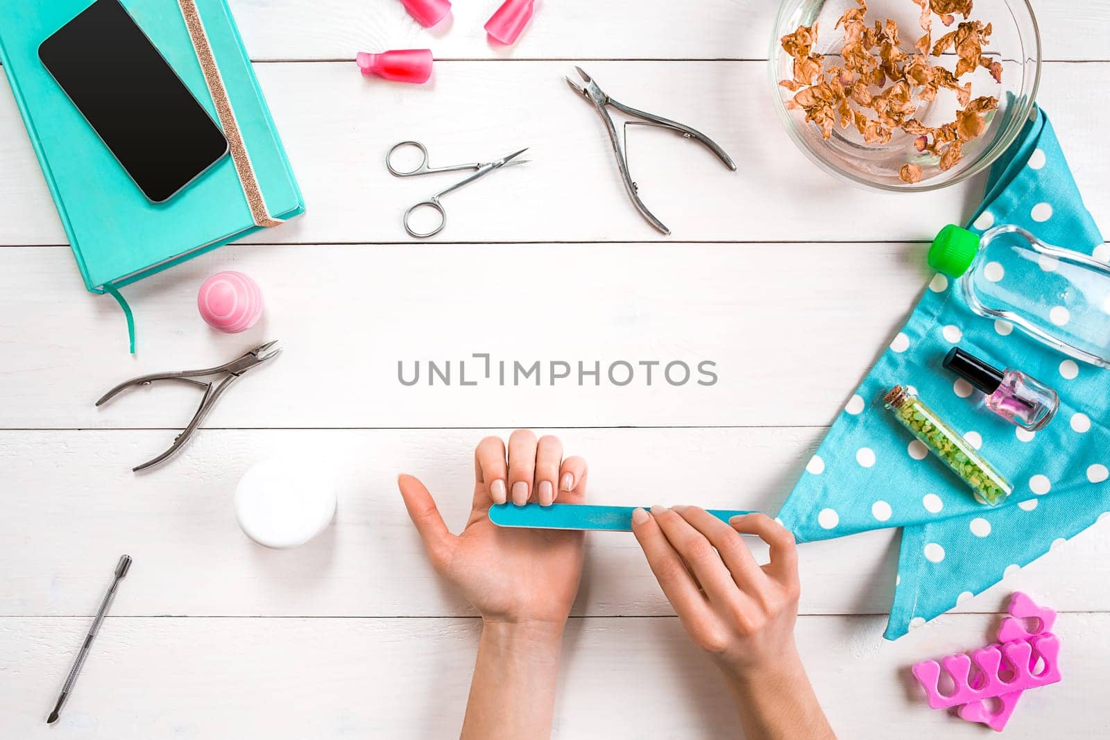 Manicure set and nail polish on wooden background. Top view. Copy space. Still life. Nail Care.