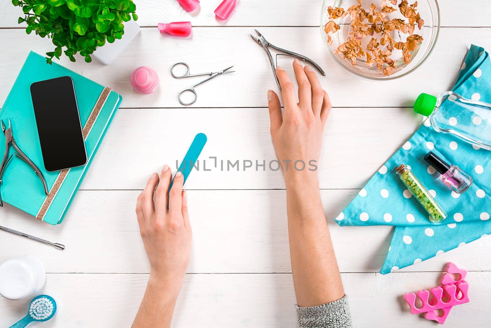 Manicure set and nail polish on wooden background. Top view. Copy space. Still life. Nail Care.