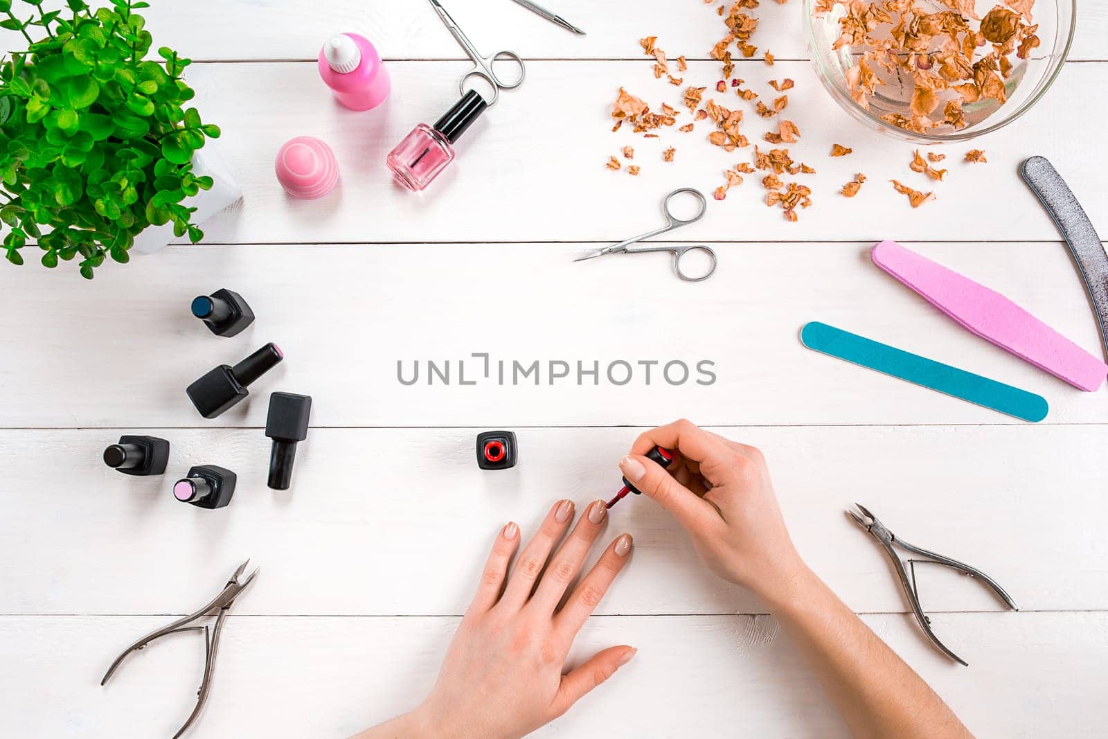 Paint your own nails. Manicure set and nail polish on wooden background. Top view. Copy space. Still life. Nail Care.
