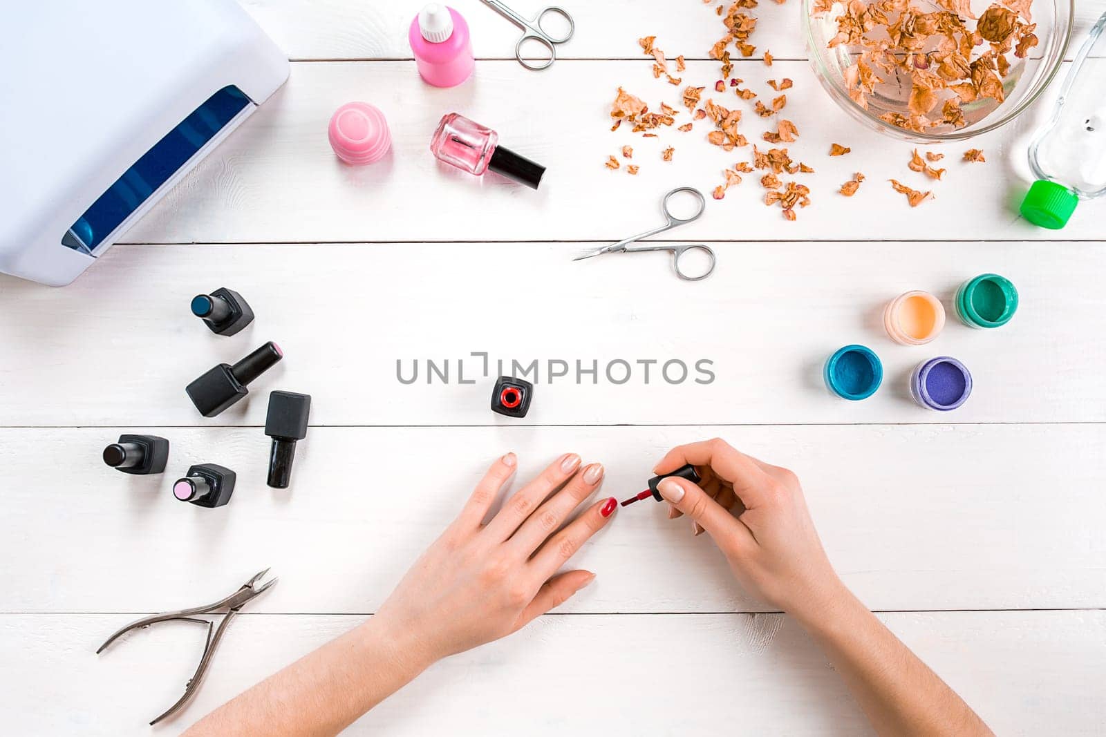 Paint your own nails. Manicure set and nail polish on wooden background. Top view. Copy space. Still life. Nail Care.