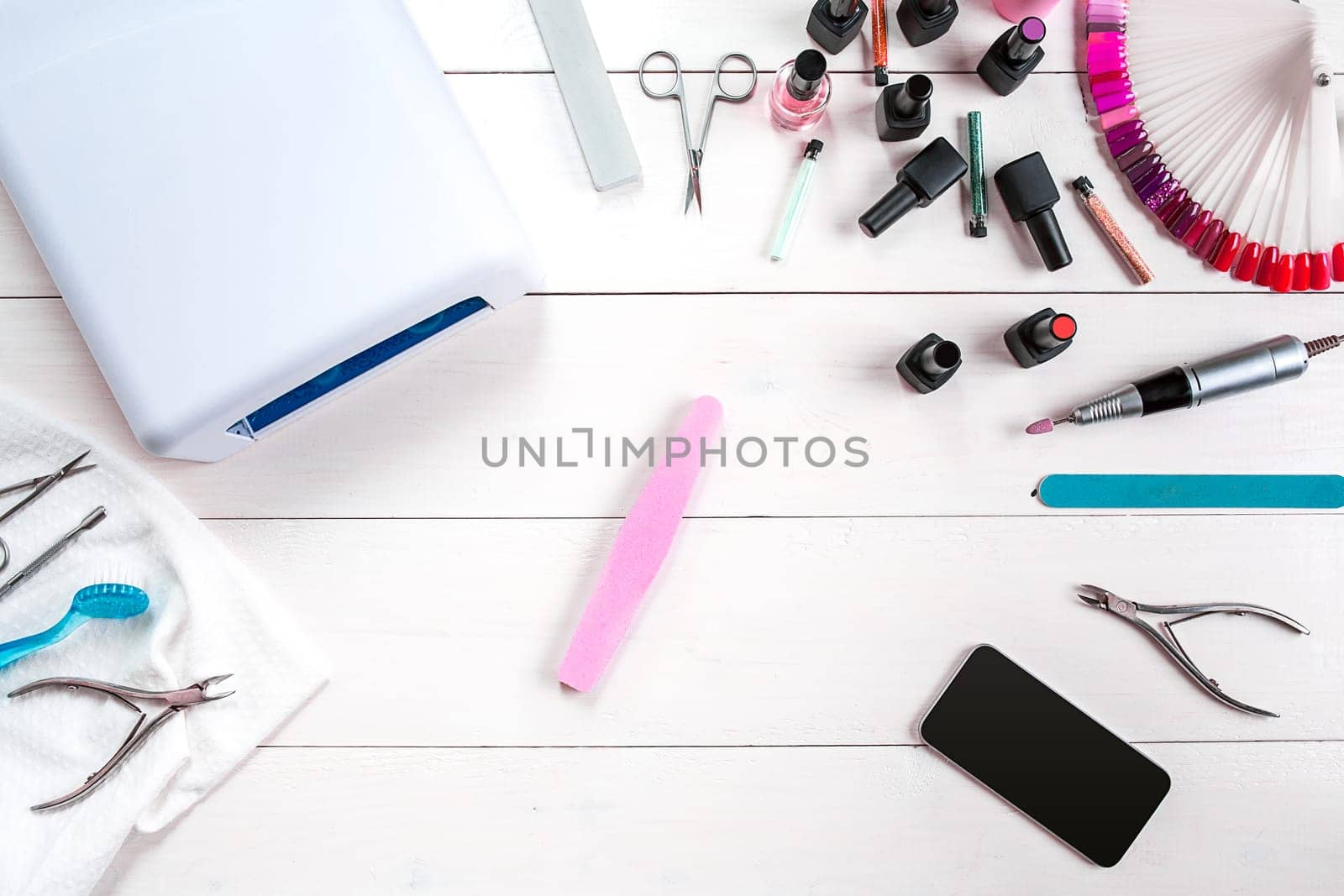 Manicure set and nail polish on wooden background. Close up. Top view. Copy space