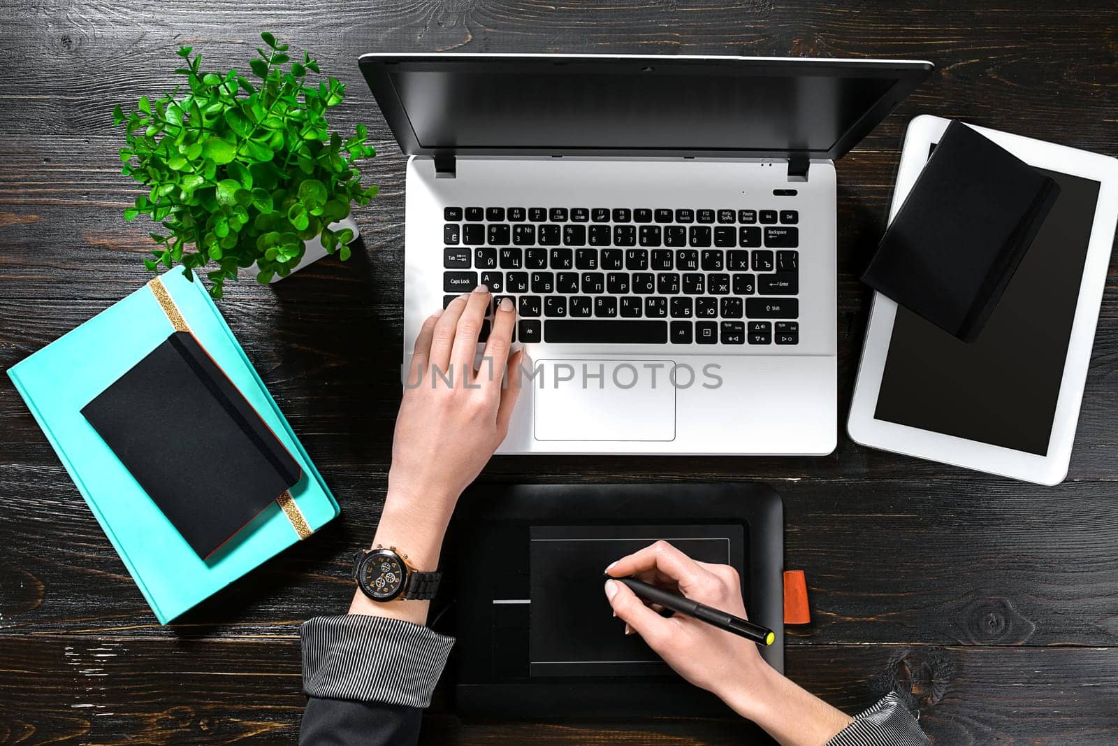 Overhead view of businesswoman working at computer in office by nazarovsergey