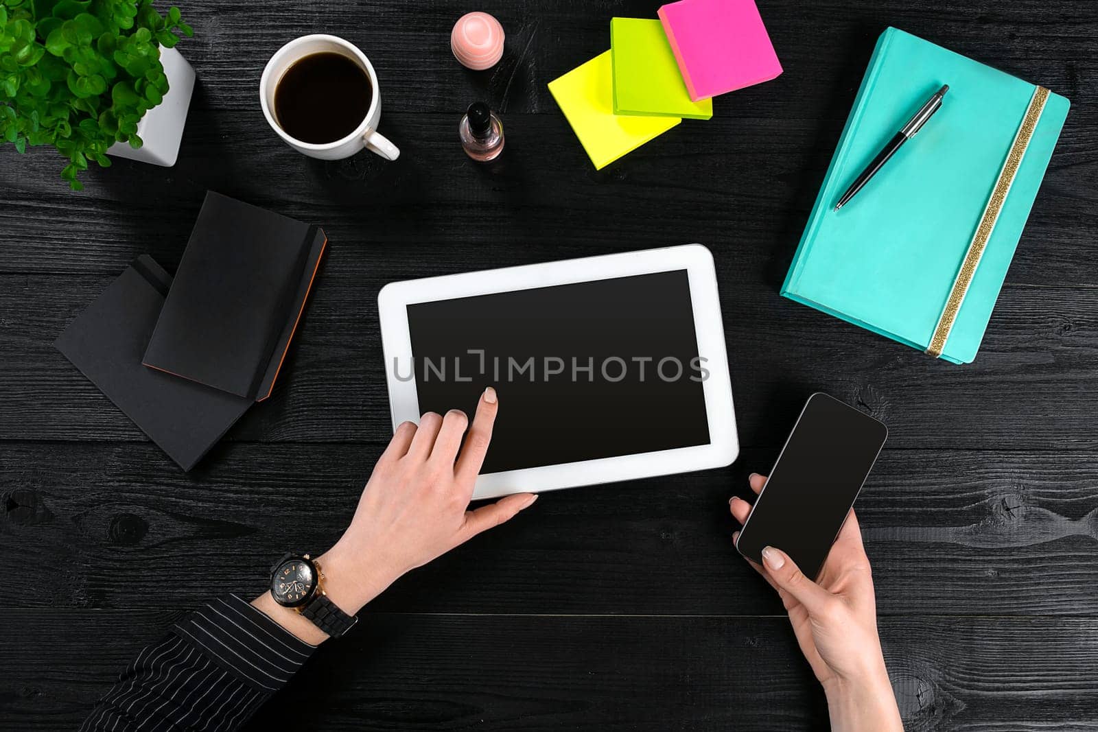 Hand use tablet on desk table top view. Copy space. Flat lay