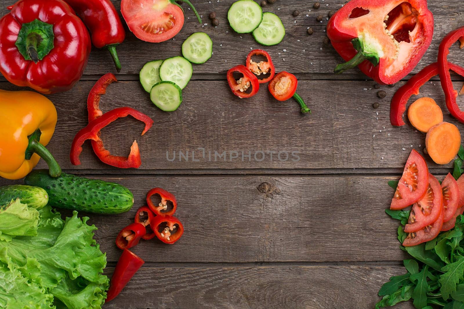 Sport and diet. Sliced Vegetables. Peppers, tomatoes, salad on rustic background. Top view. Copy space