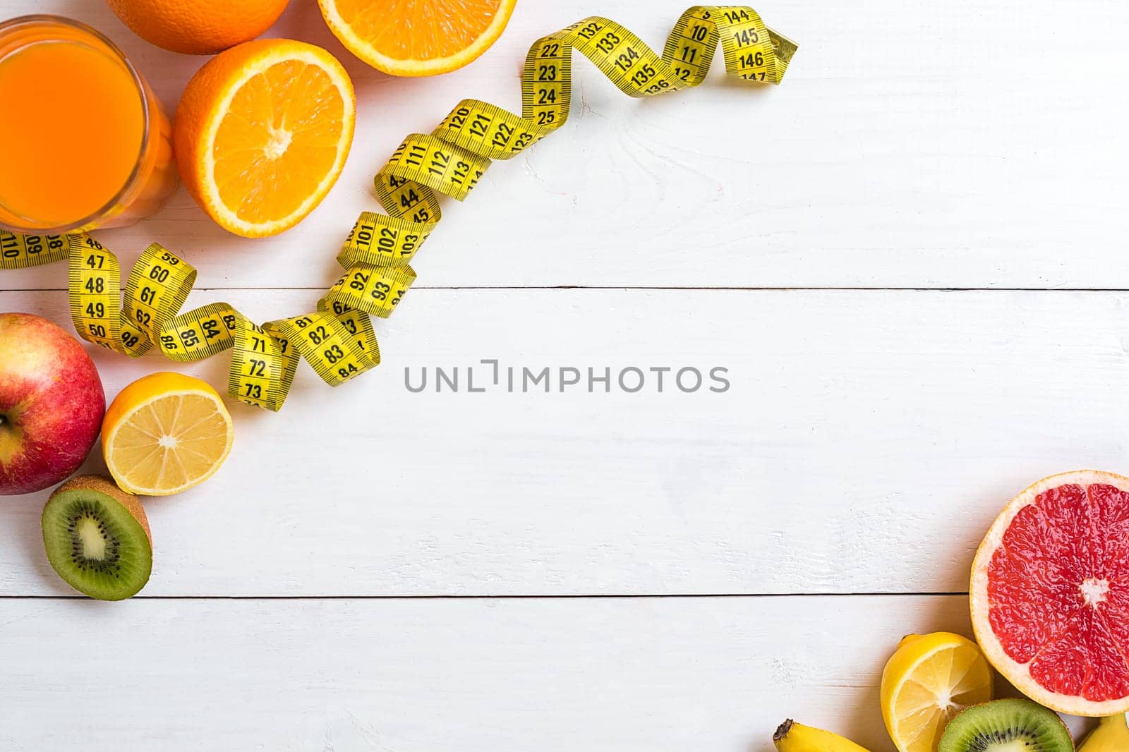 Fitness concept with fruit, bowl of oatmeal and centimeter. Top view background concept. Copy space