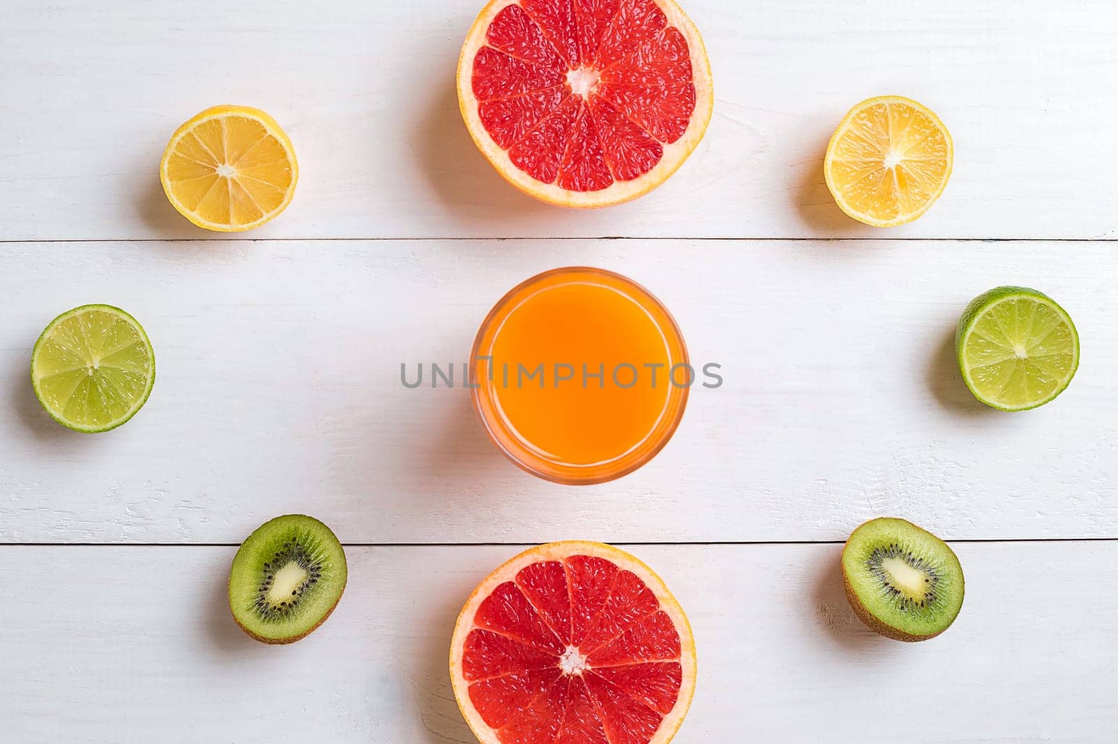 Various citrus fruits with a drink on the table. Top view. Copy space.