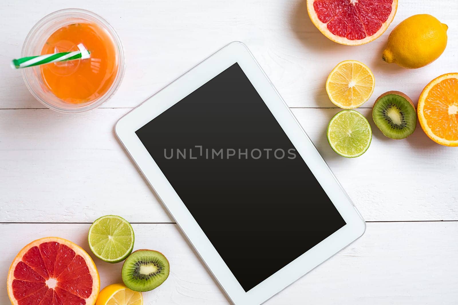 Fresh fruits with tape measure over white wooden background. Fitness concept. Top view. Copy space Flat lay