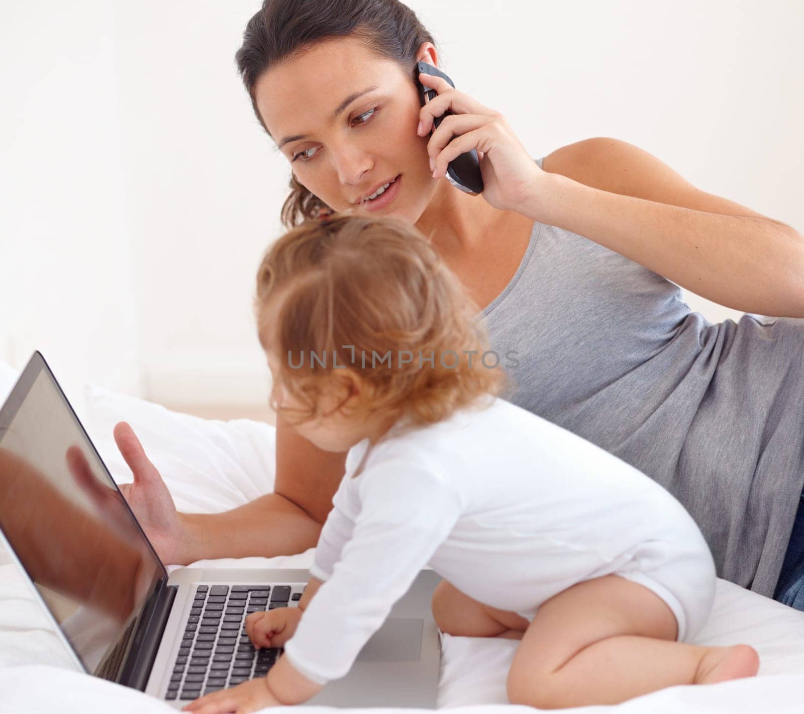 Id like to check my email...Image of a baby girl playing with her mothers laptop. by YuriArcurs