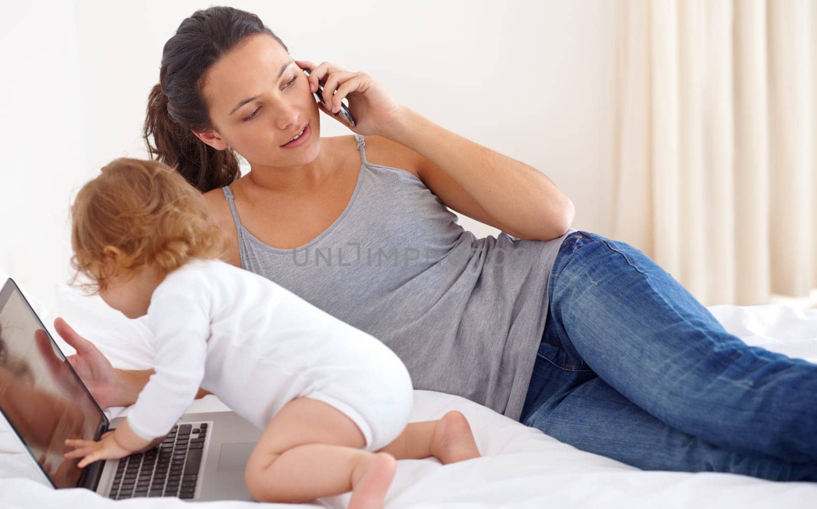 Exploring whiellef. Image of a baby girl playing with her mothers laptop
