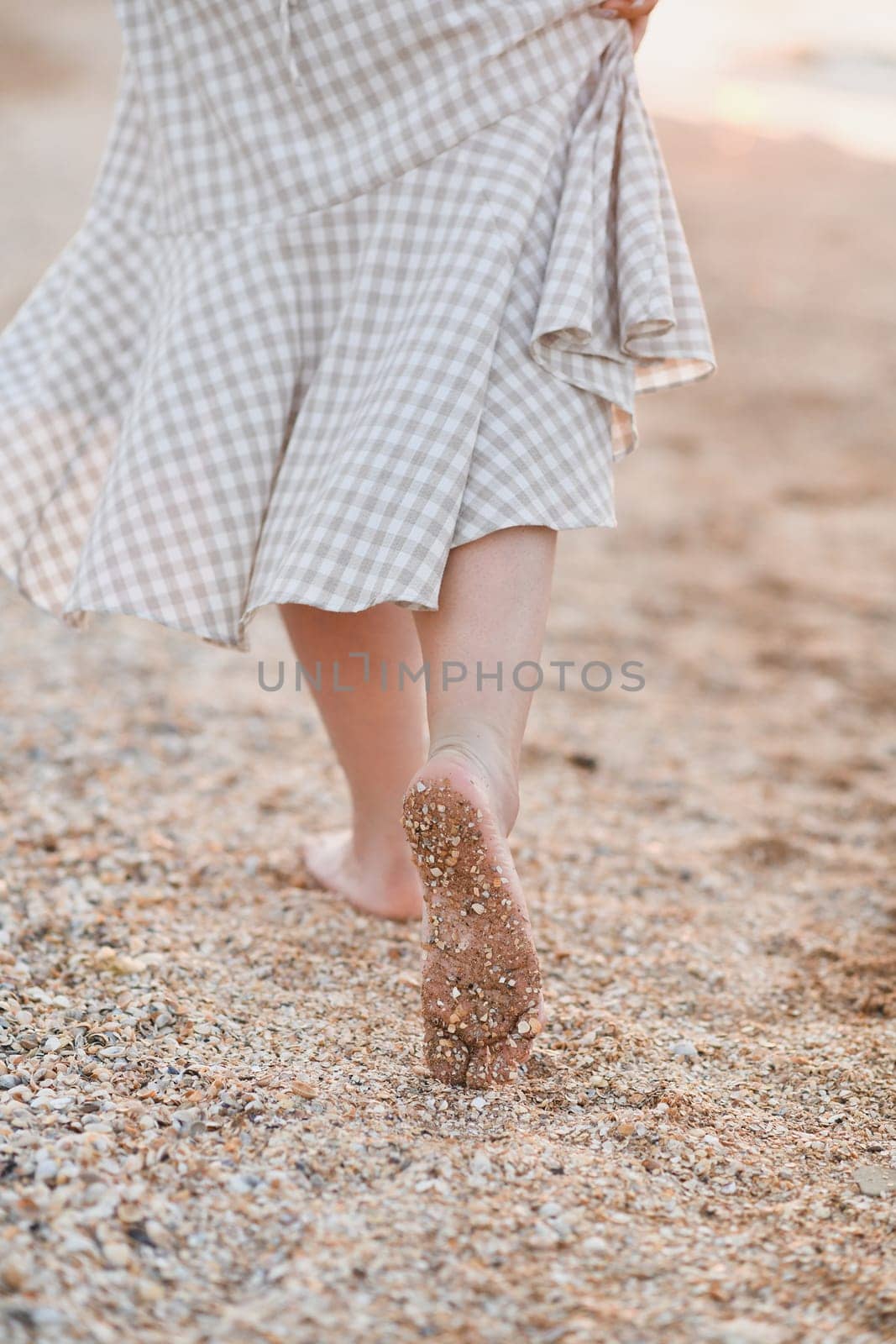 Sand on women's feet and heels on the coast