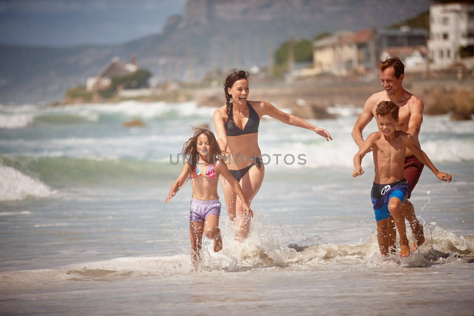 Theyre a family who knows how to have fun. a family playing in the waves at the beach